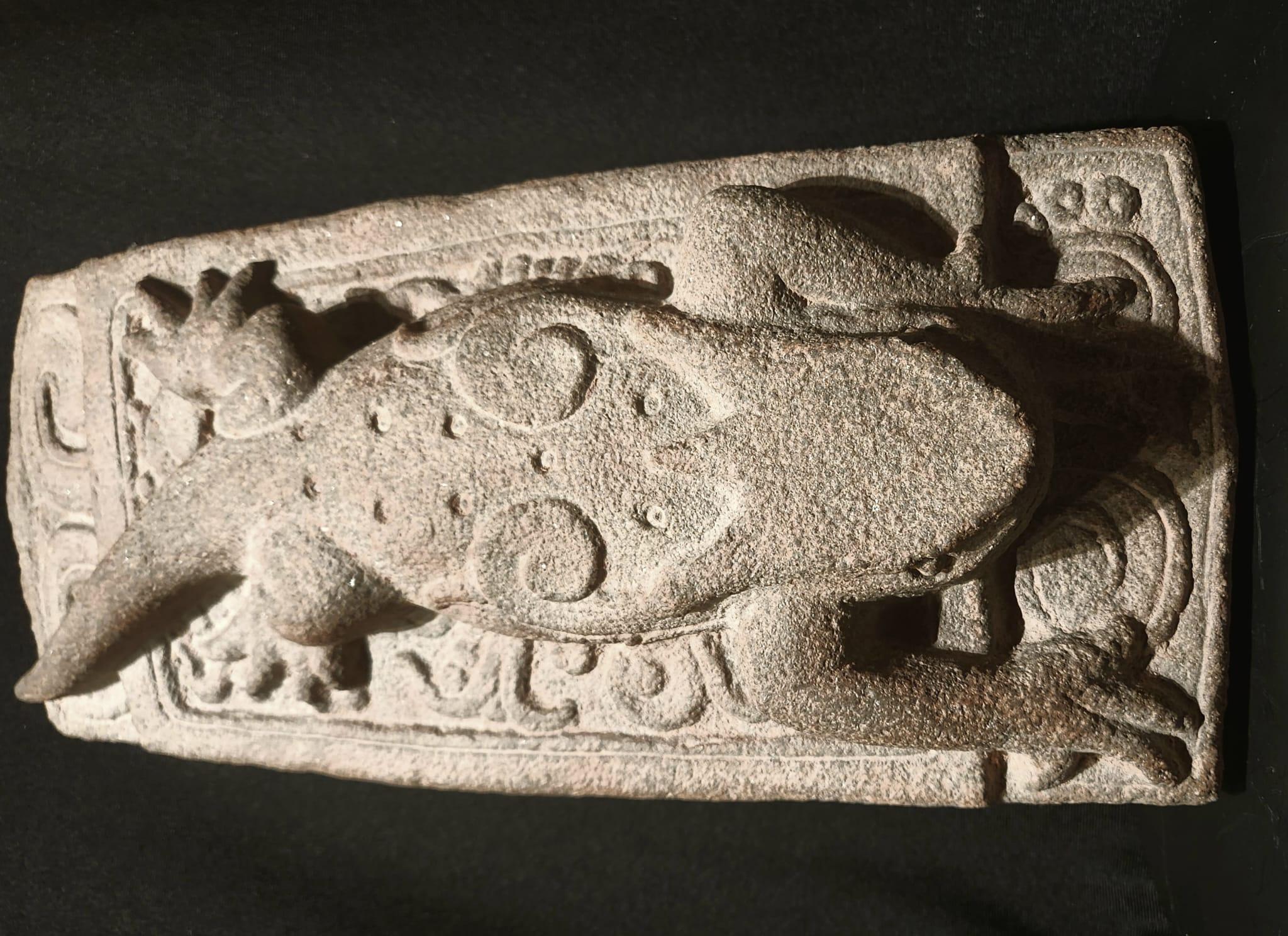 A superb relief-carved panel depicting the Maya Deity Itzamna, appearing as an Iguana, stretched out on a platform with long-toed limbs splayed