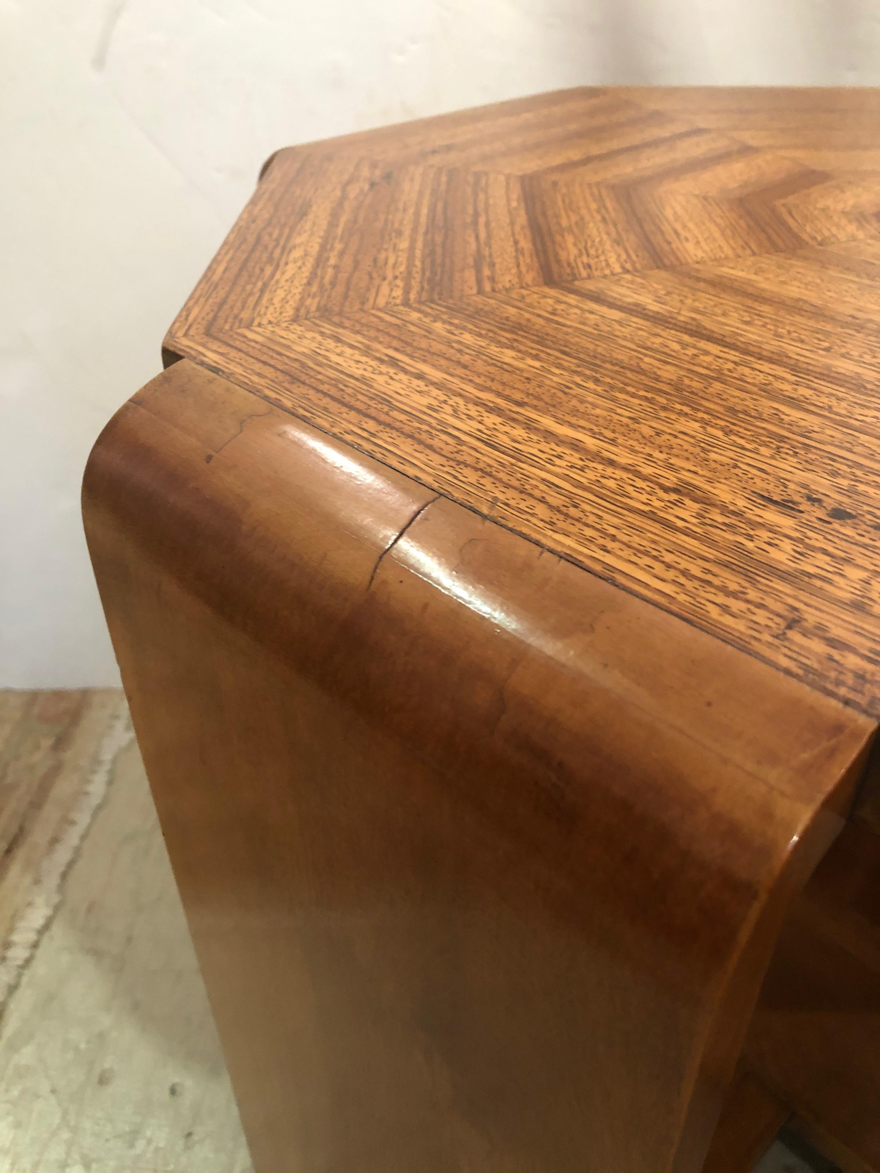 A wonderful octagonal shaped Mid-Century Modern end table having fantastic geometric pattern on top and having 4 sleek sculptural sides that become legs with stunning criss cross stretchers. Very solid and sturdy.