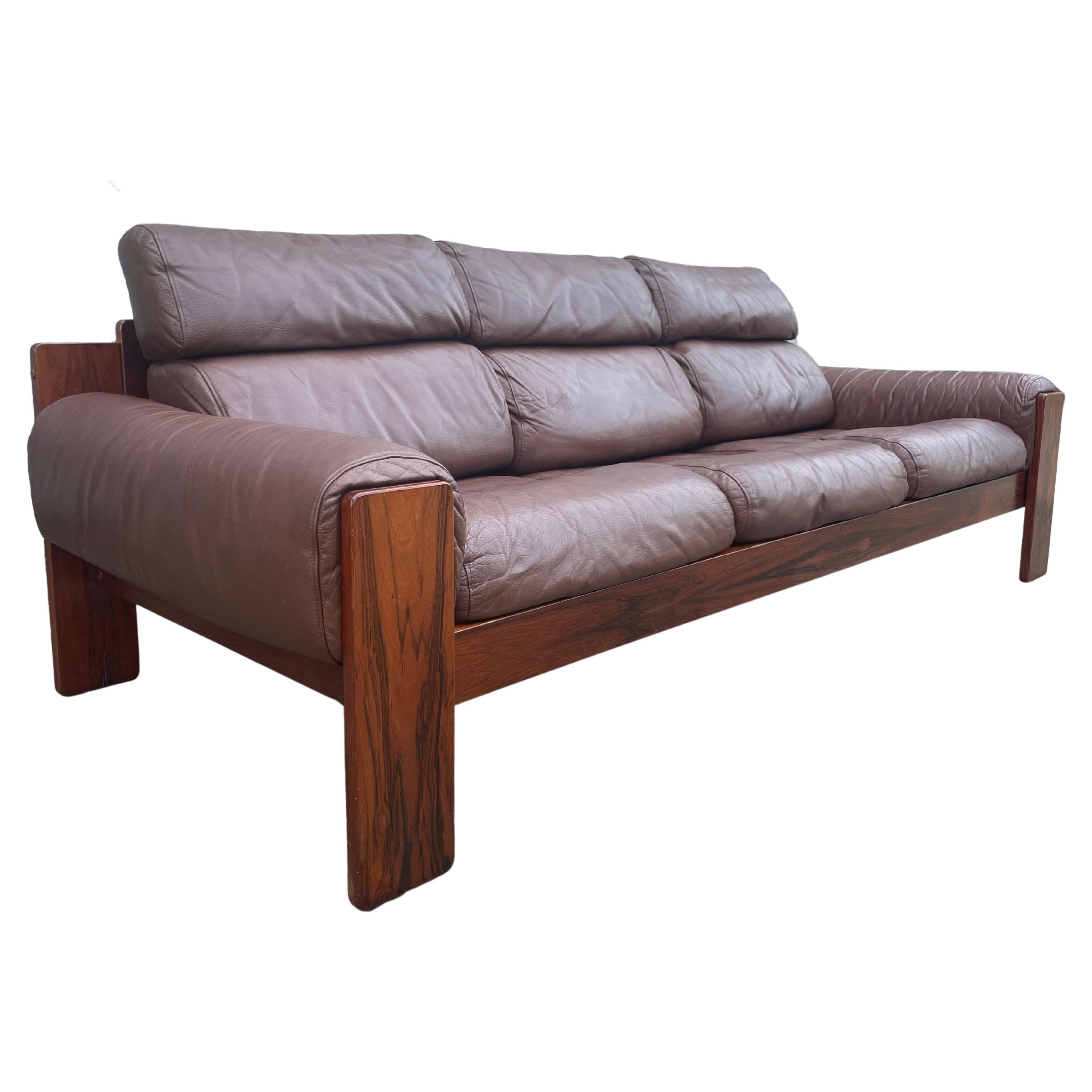 Superb mid-century Scandinavian flat rosewood frame is low profile with Soft padded Brown colored leather cushions. Very cozy low Scandinavian modern design by Uu-Vee Kaluste Oy of Finland. Circa late 1960. Very very clean and shows very light use.