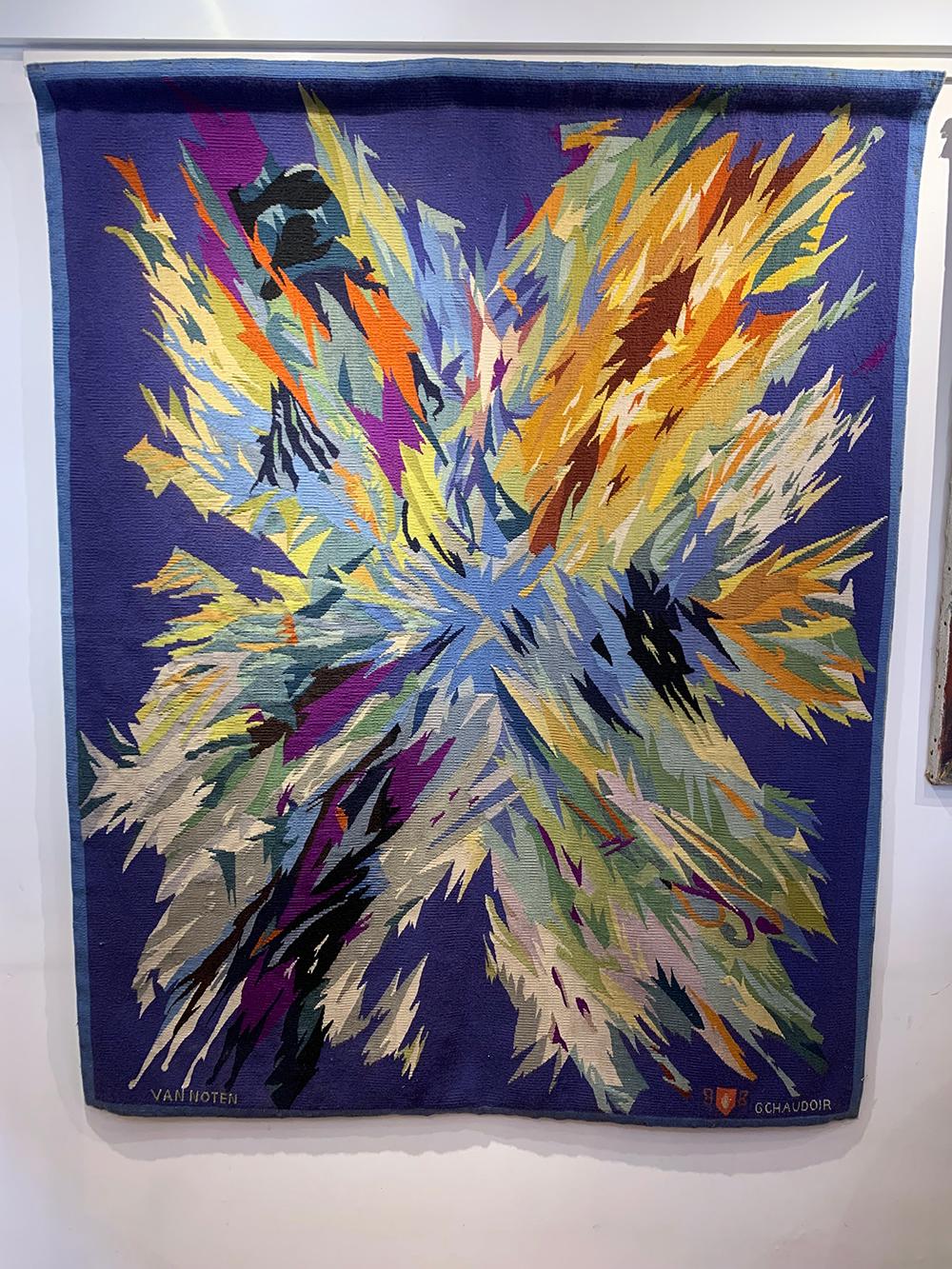 Colorful abstract mid-century tapestry having a blue background with beautiful explosion of colors, from the house of Chaudoir and designed by Artist Van Noten.