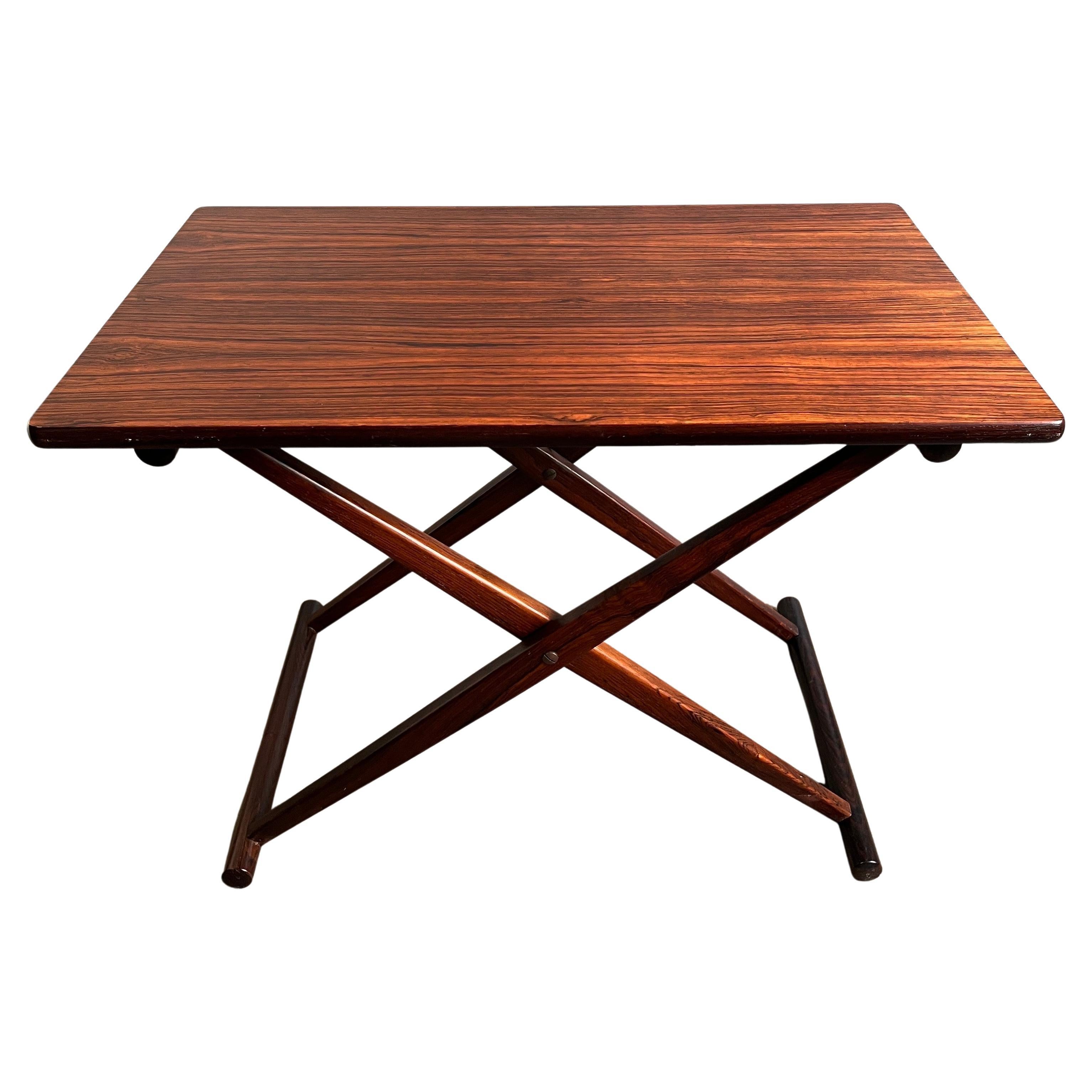 Model ka 128
Beautiful and rare rosewood folding table made in Denmark. Designed for compact portability. This versatile table can be used and a side table, end table, tray table etc..
solid framed rosewood construction. Original condition
