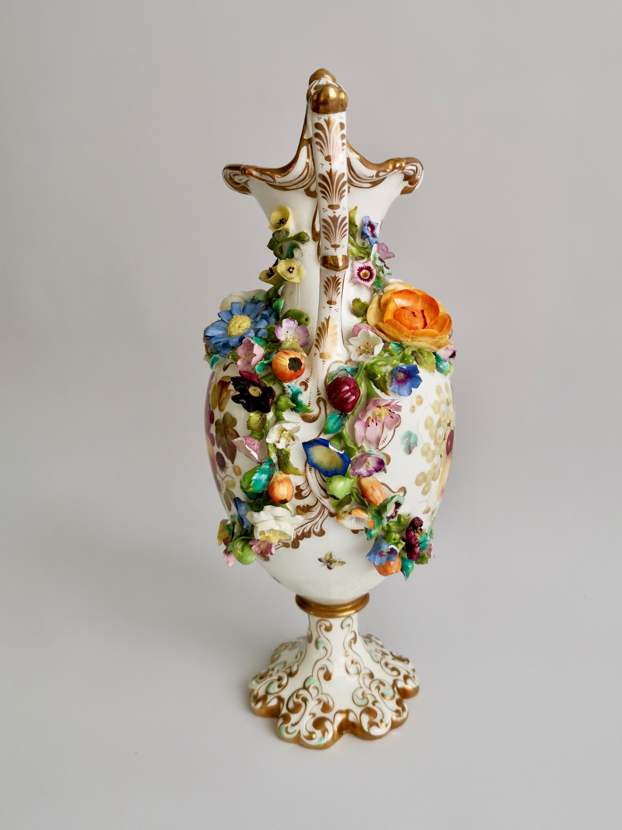 This is a superb porcelain vase made by Minton between 1830 and 1835, which was the Rococo Revival period. The vase is encrusted with fruits and flowers, and painted with sublime fruits by the famous painter Thomas Steel. 

Minton was one of the