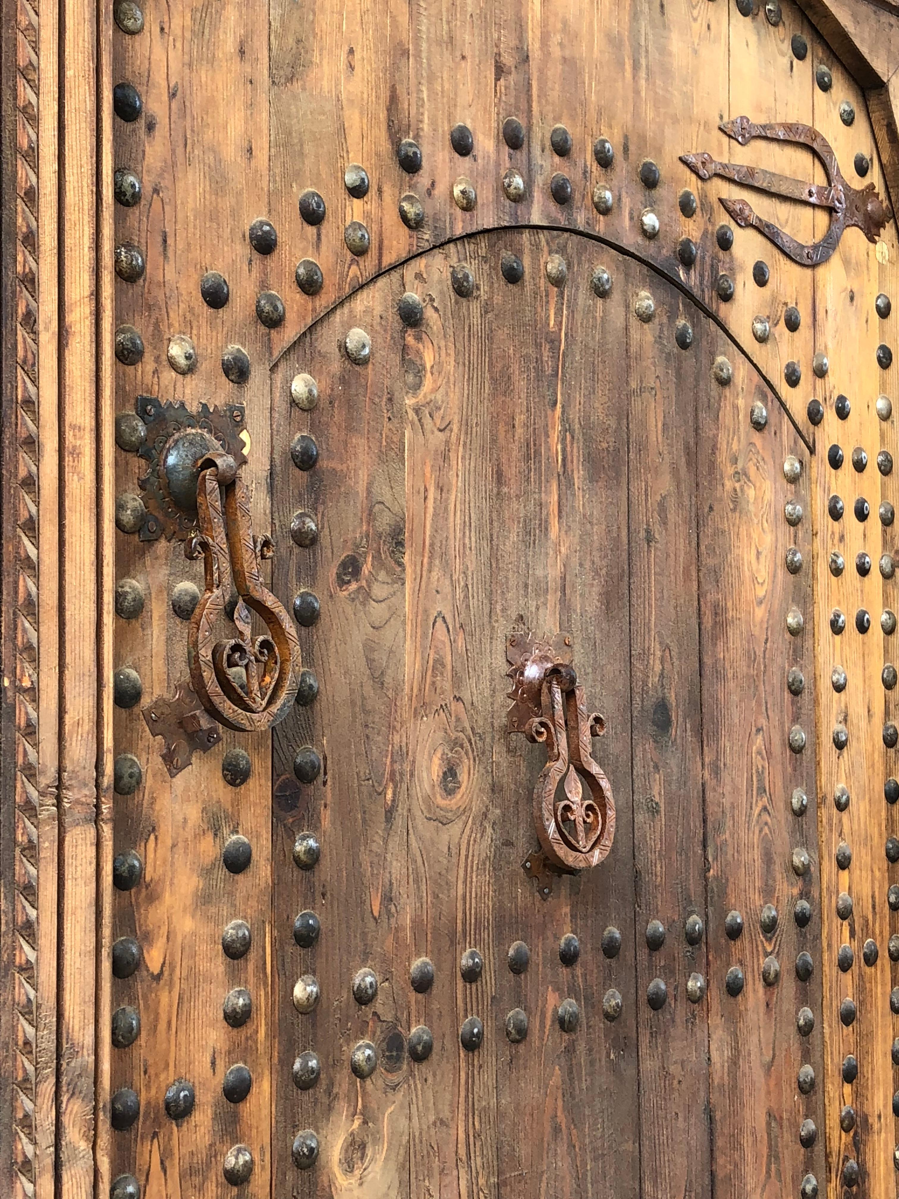 
Moorish Moroccan handmade and hand carved indigenous cedar and local white wood door adorned with Moorish traditional nails heads and hand forged hardware. Moroccans used these kind of doors for centuries, great workmanship, sturdy & solid. This