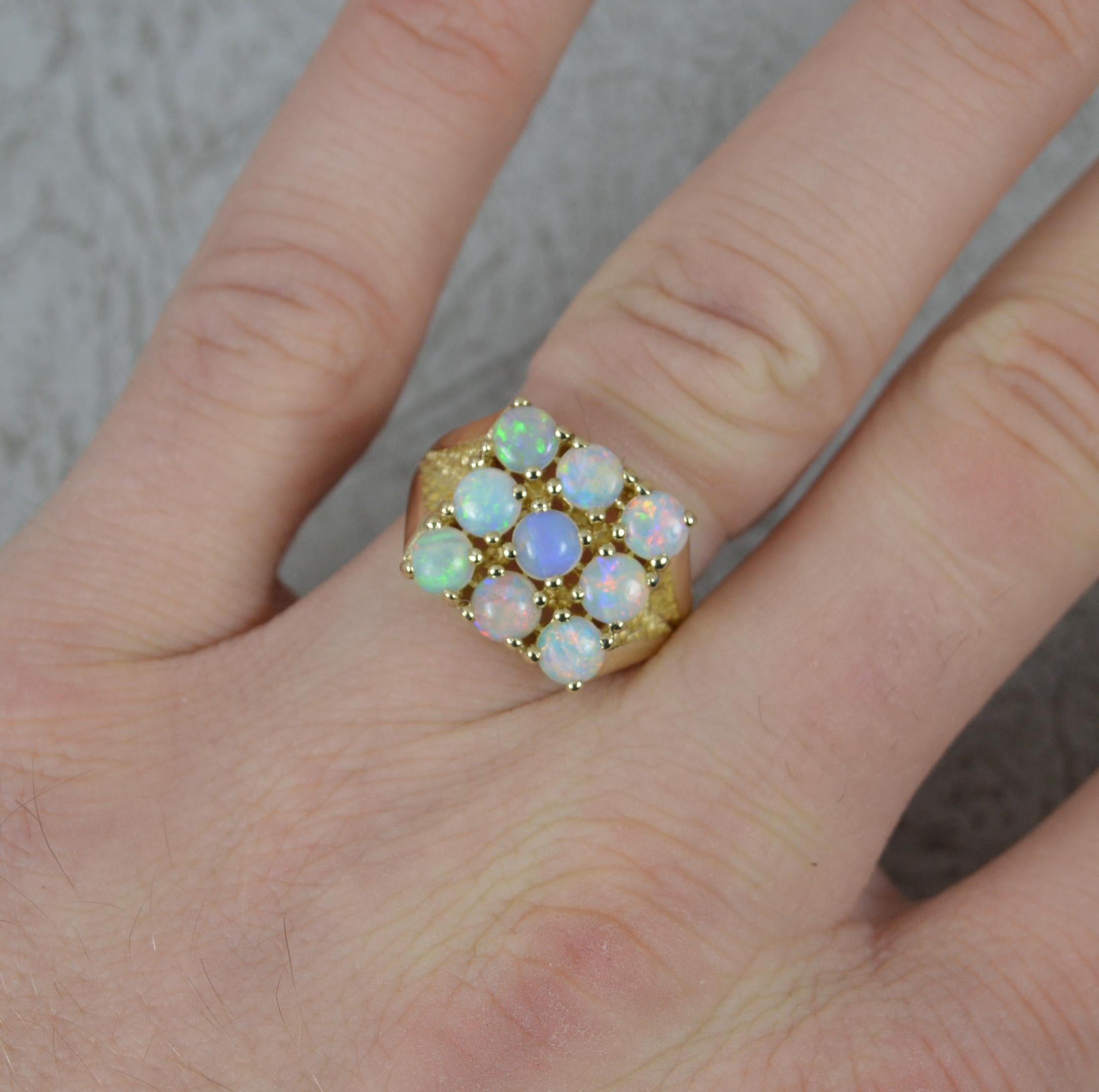 A fine quality opal cluster ring in 9ct gold ring.
Set with nine natural opals in a 3x3 grid.
13mm x 13mm head.

Condition ; Very Good. Clean, solid band. Well set stones, issue free. Please view photographs.
Size ; M 1/2 UK, 6 1/4 US
Weight ; 5.0