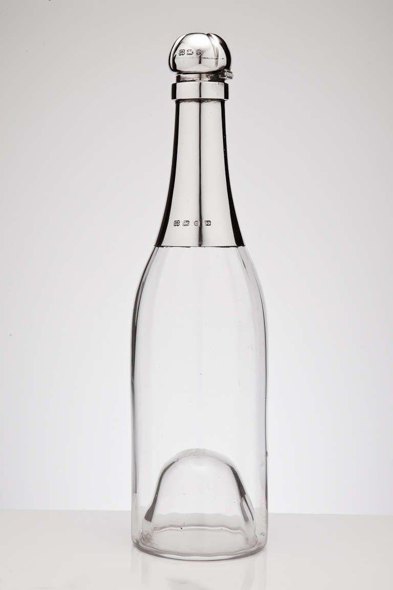 A superb novelty champagne bottle with English silver mounts dated Birmingham 1893 by maker Heath Middleton.  

Clearly its streamlined design was very much ahead of its time.

It makes a nice conversation piece when entertaining & ideal as a