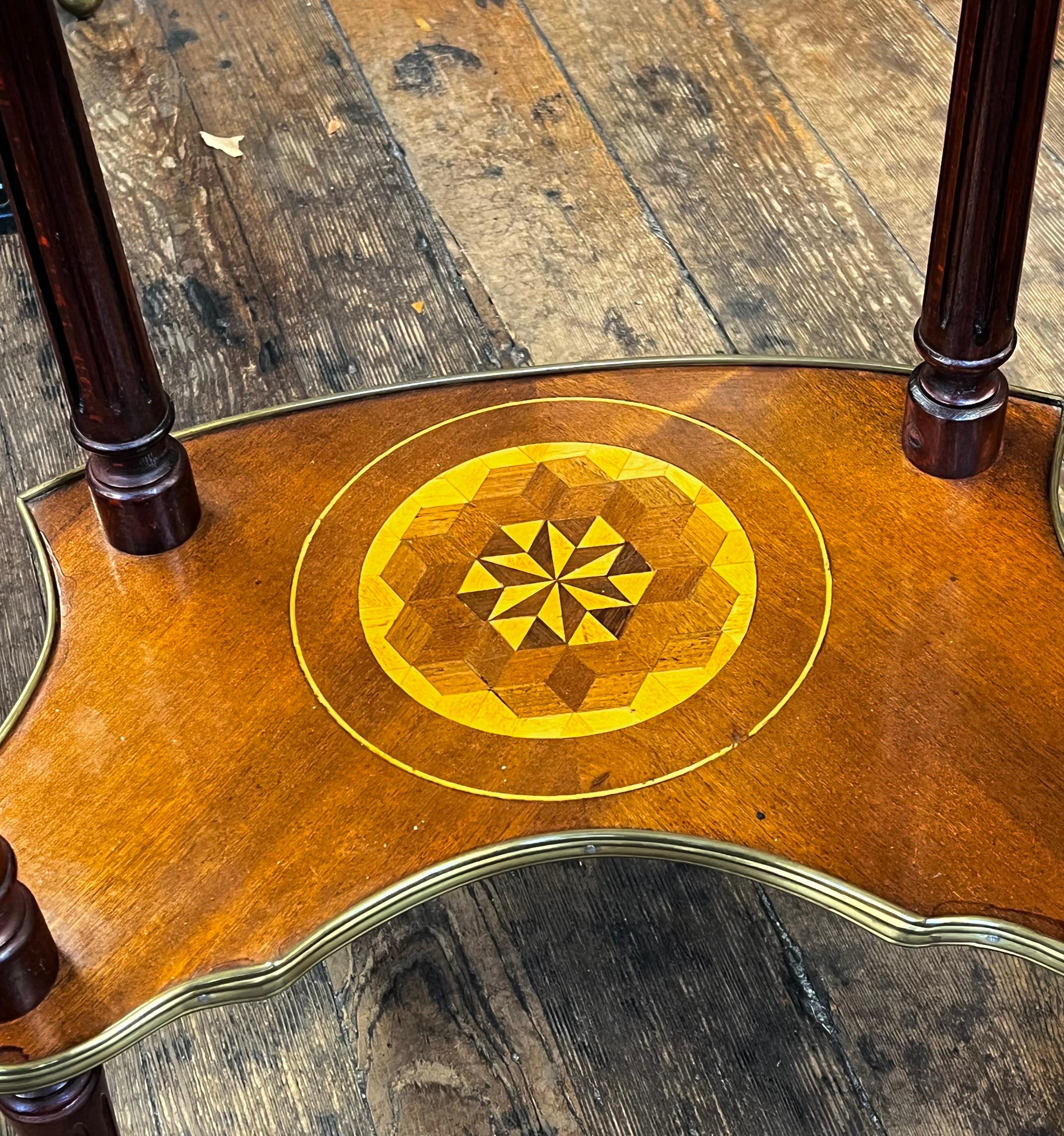 A lovely, hand-made Old French marquetry inlaid kidney shape side table or end table with fabulous exotic wood marquetry inlays of mahogany, satinwood, pearwood, rosewood and walnut. Also boasting ormolu (gilt brass) mounts and a delicate