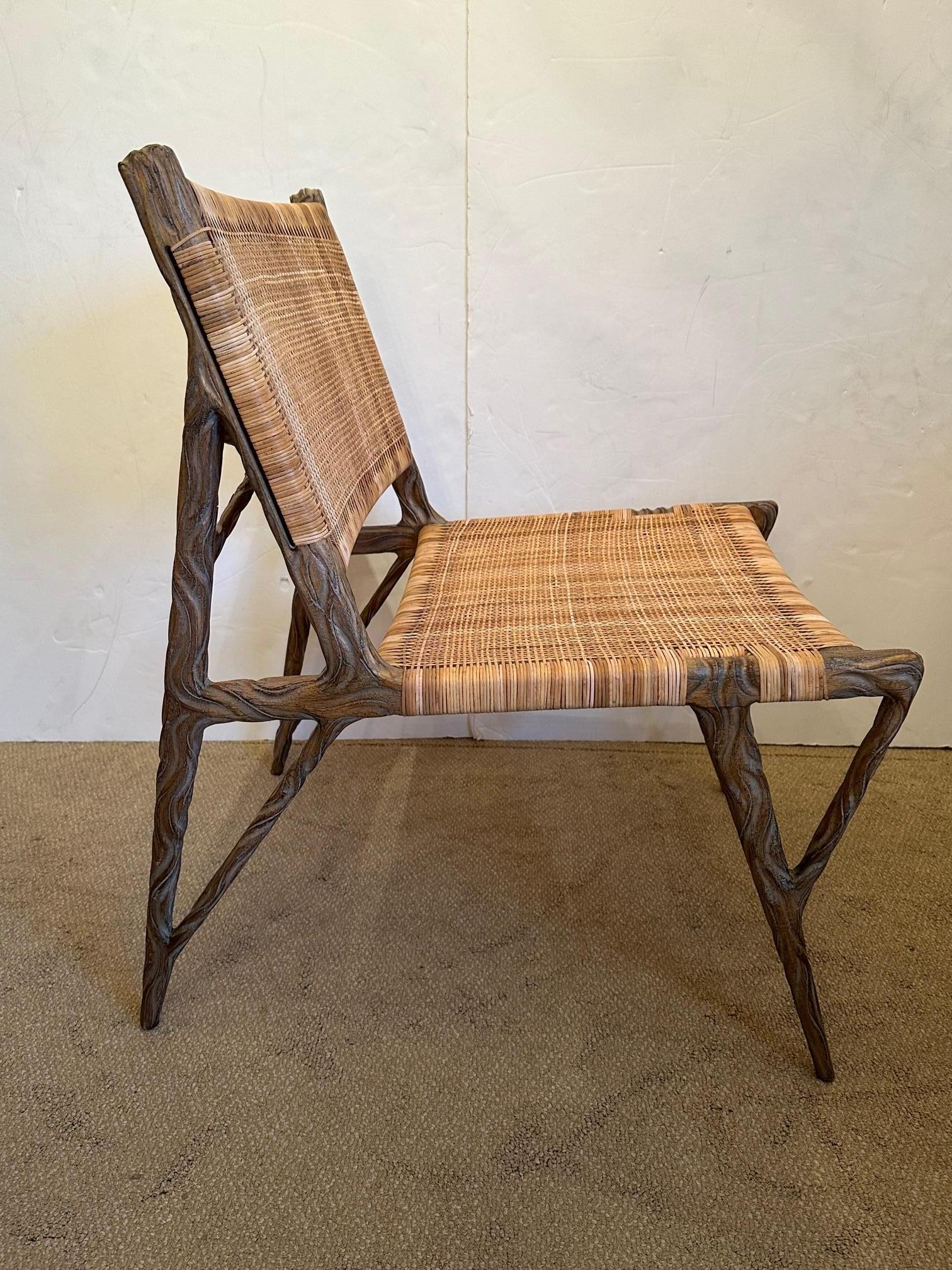 Superb organic modern occasional chair having sculptural faux bois twig like structure and shapely legs with woven natural colored rattan seat and back. This is the favorite chair in a room for it's forward design and natural feel.
Measures: Seat
