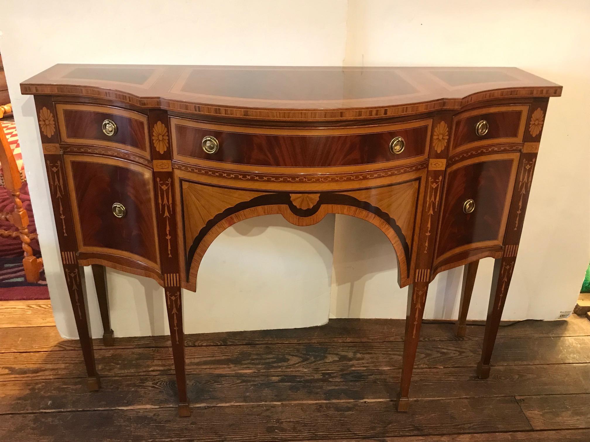 Absolutely gorgeous meticulously inlaid mixed wood console, sideboard or credenza, having 3 drawers across the top and two side panel doors that open outward to reveal storage.