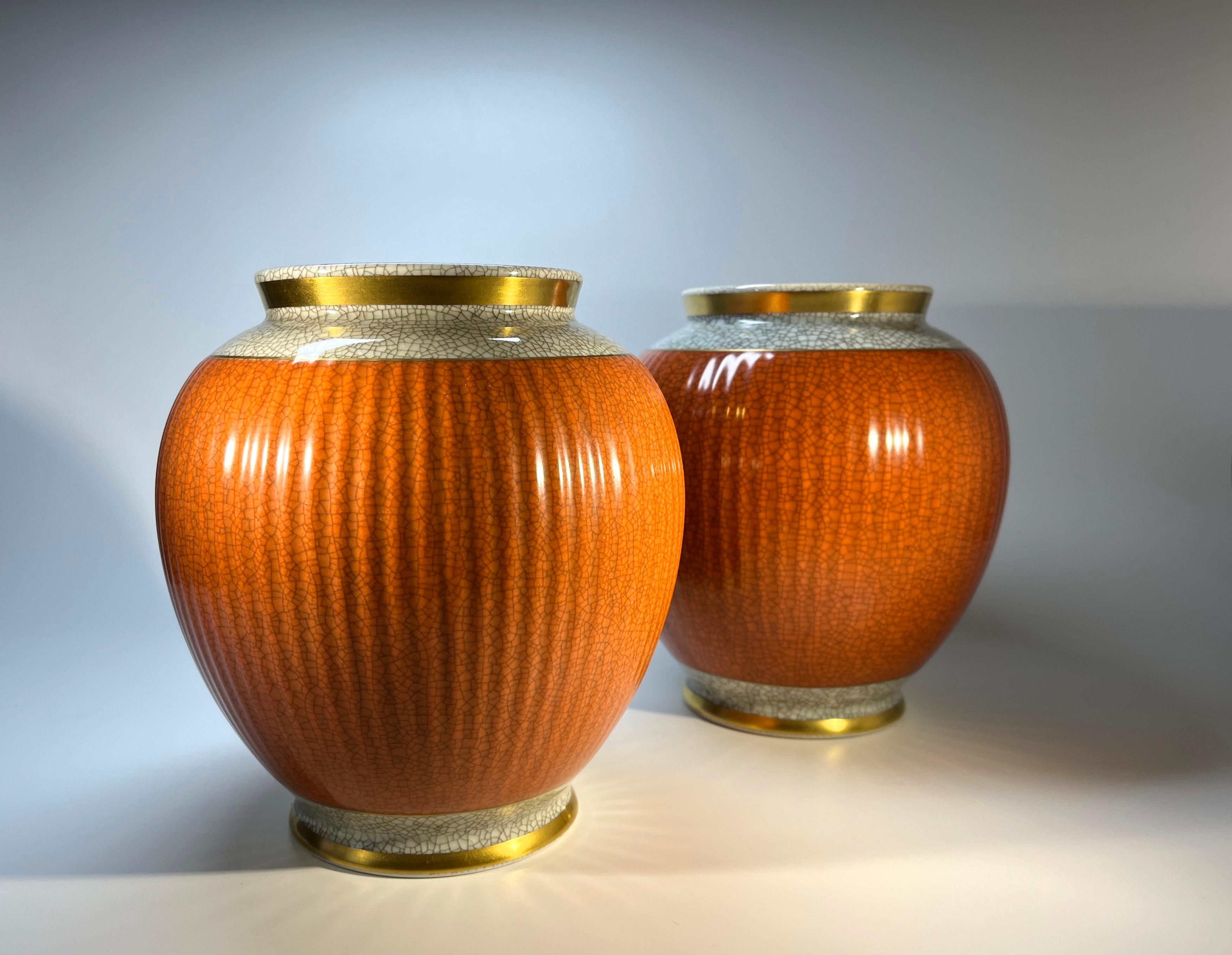 Dating from the 1950's, a stunning pair of Thorkild Olsen for Royal Copenhagen, porcelain terracotta and grey crackle glazed shaped vases
Features gilded banding on neck and base.
Date stamps are 1950 and 1957 
Stamped and numbered 2781
Height 7.25