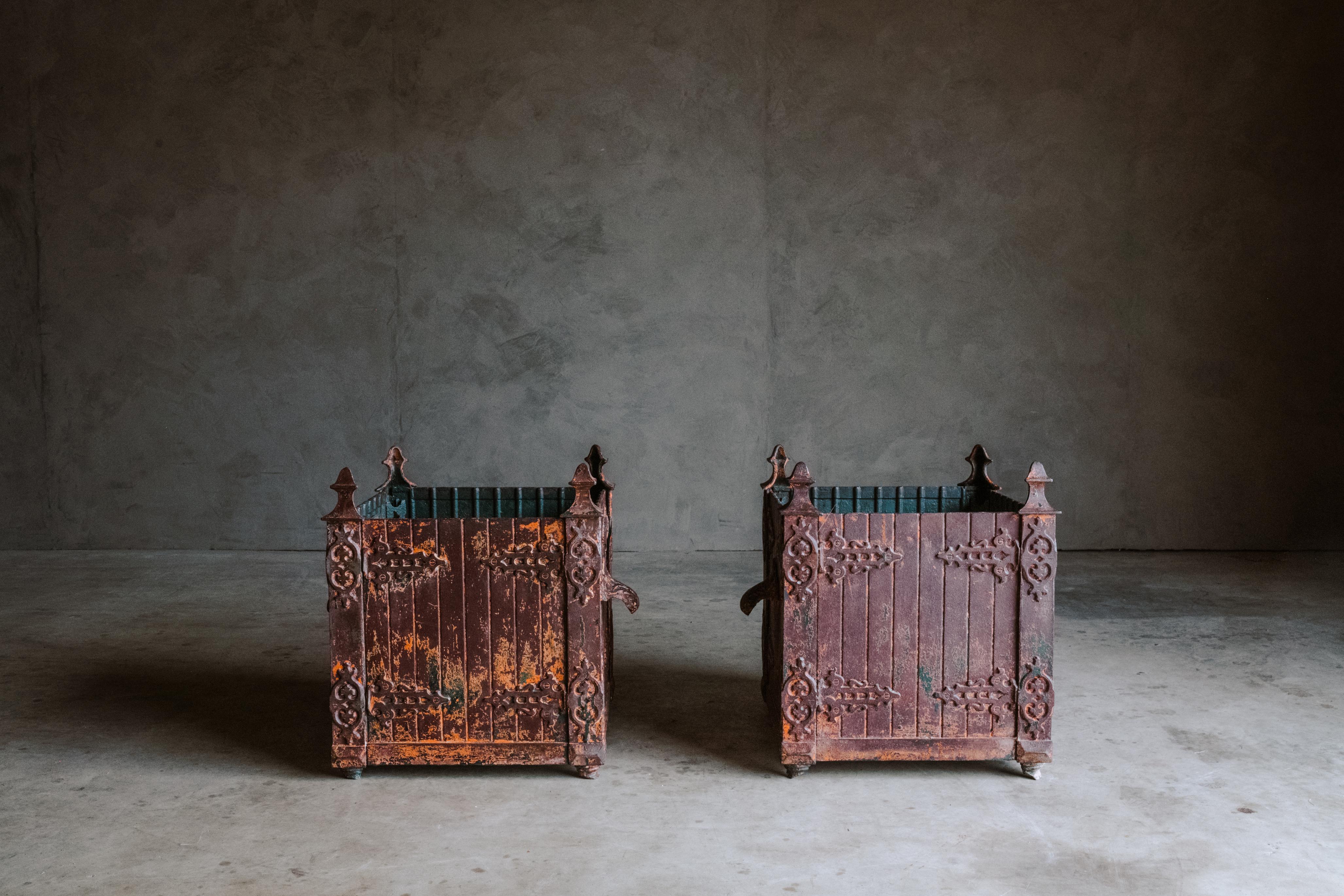 Superb pair of cast iron orangery planters from France, Circa 1880. Solid Iron assembly with handles and fantastic original patina.
