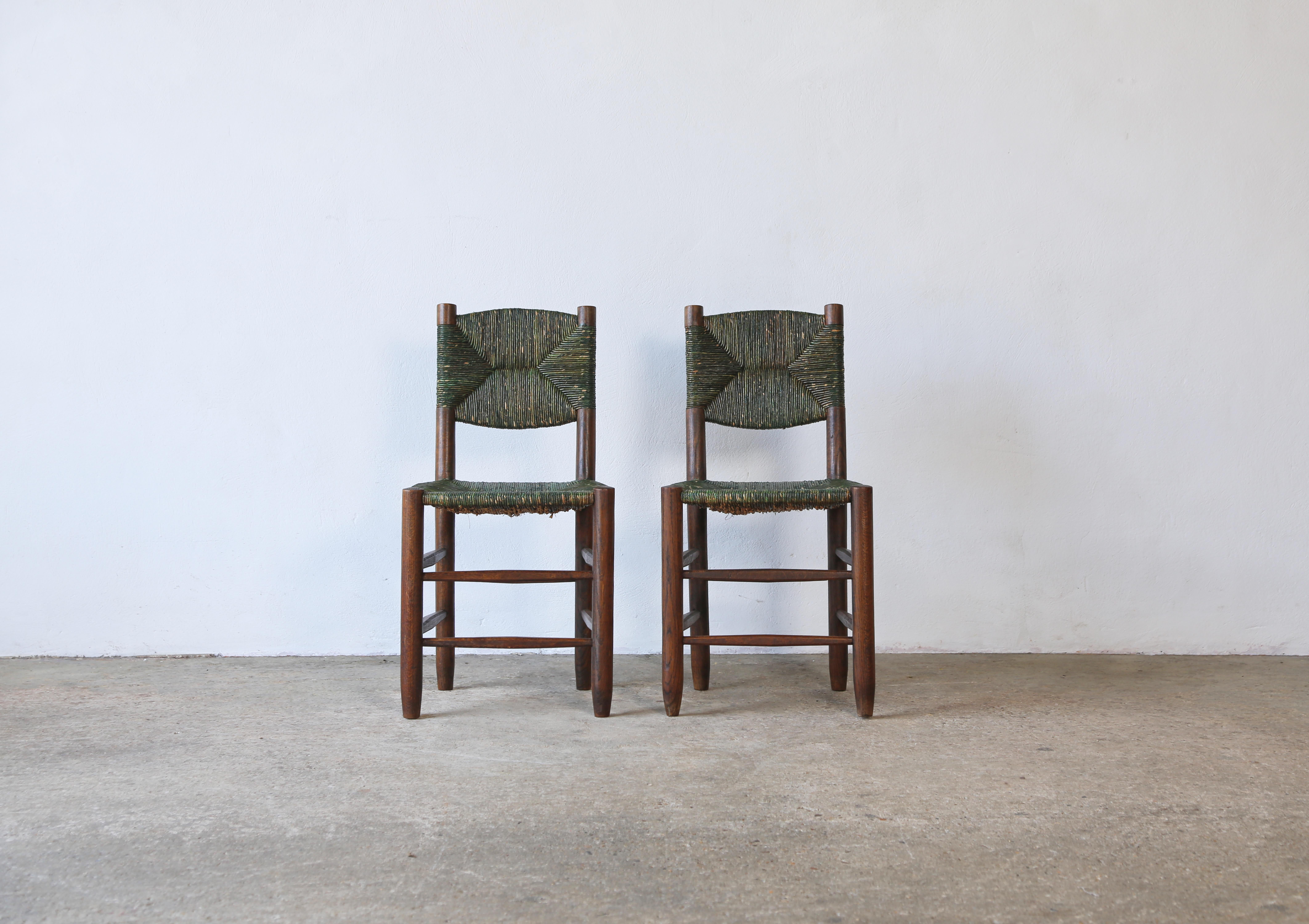 A superb pair of Charlotte Perriand Model 19 Bauche chairs, France, 1950s, with very rare green coloured cordon. These examples most likely produced by master cabinetmaker Andre Chetaille at Steph Simon. In original condition and very rarely found