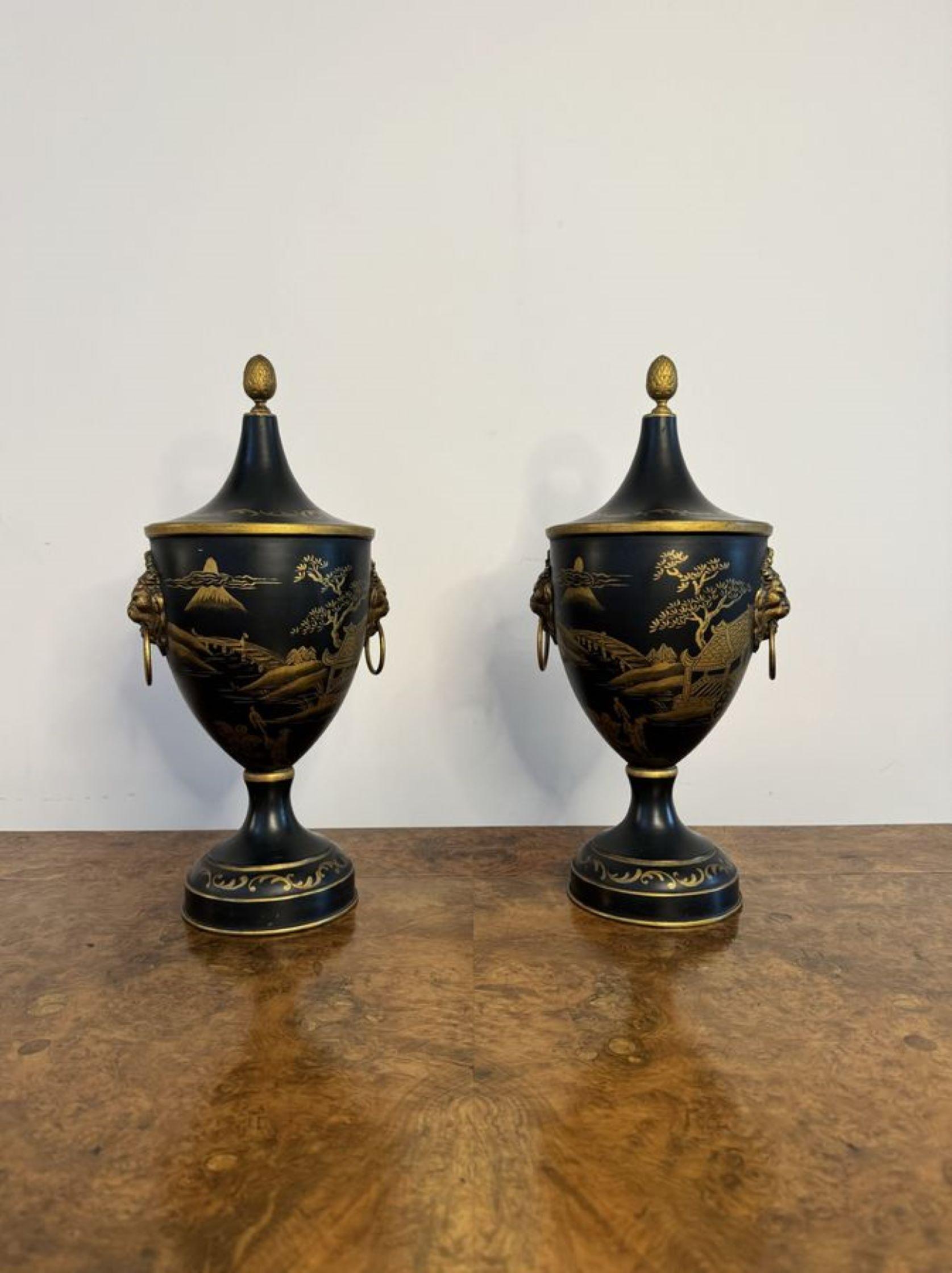 Superb pair of French hand painted toleware chestnut urns, having wonderful chinoiserie gilded decoration, with lions head mask handles to the sides, removable lids, raised on circular bases.

D. 1930