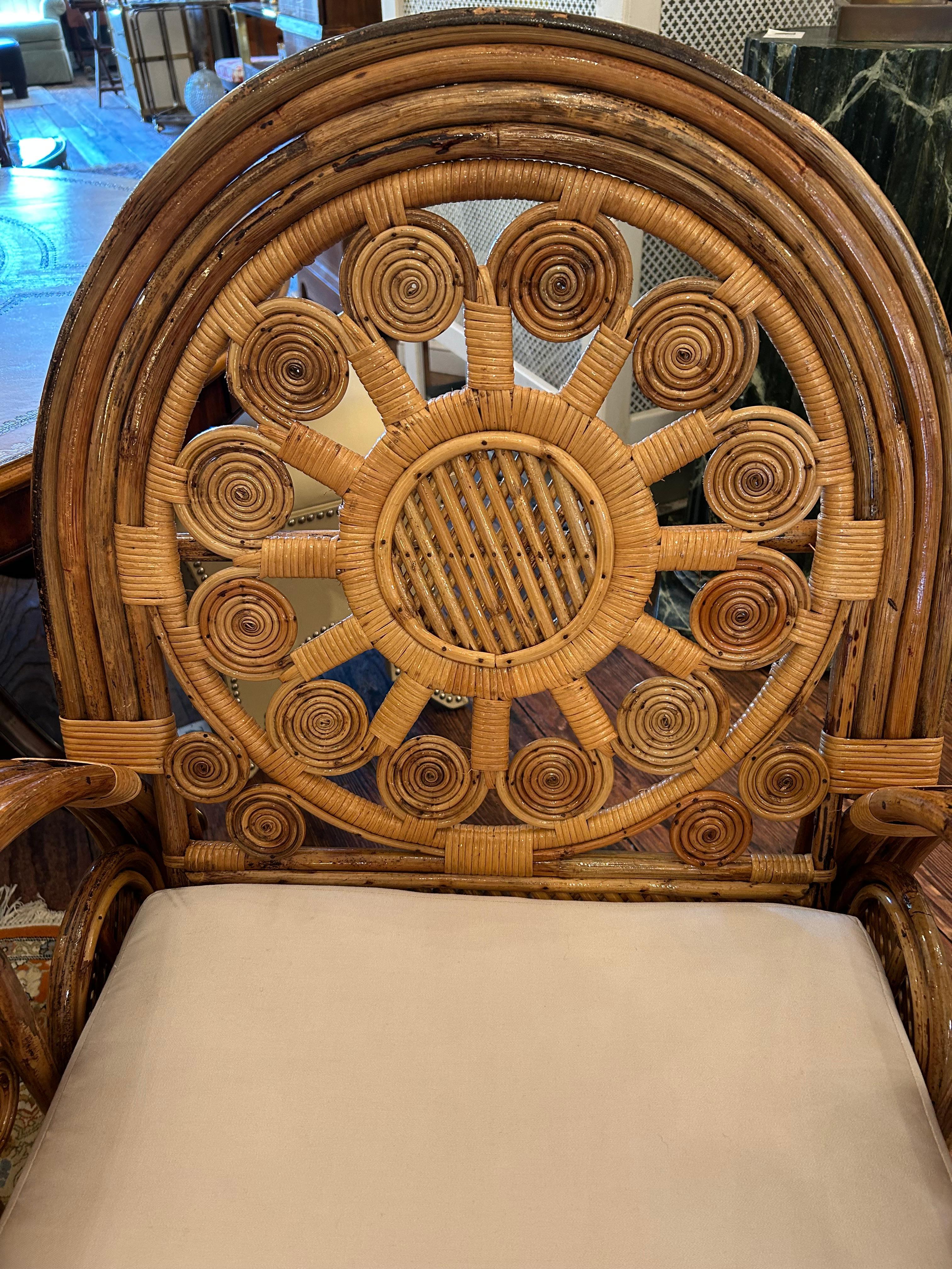 Eye poppingly dramatic large lacquered rattan bamboo club chairs having ornate design that leave a lasting impression.  Custom Sunbrella cushions.
arm height 27.5
Seat height w/o cushion 16