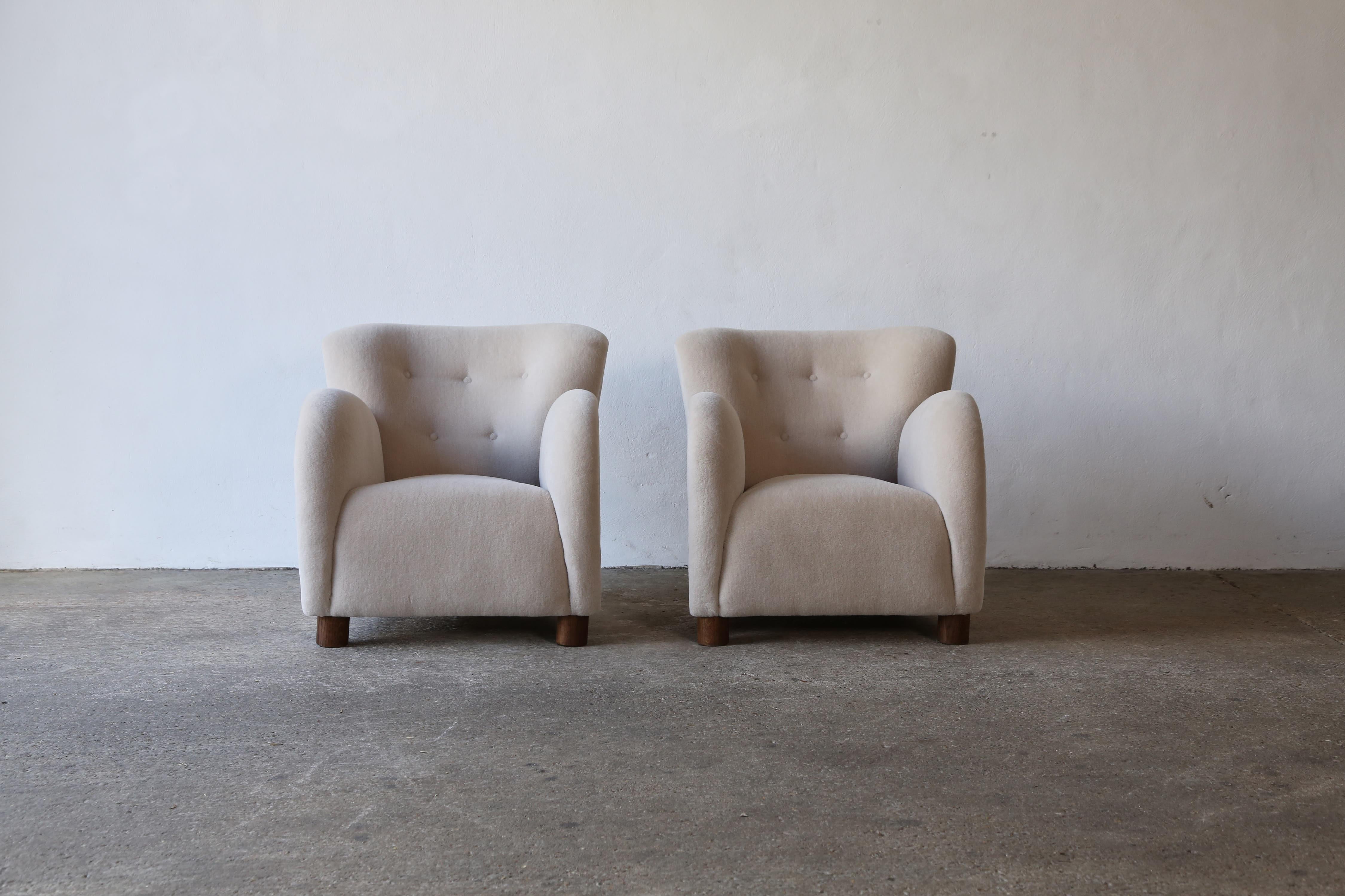A superb pair of modern round arm 1940s Danish style armchairs. Handmade beech frames and sprung seats.  Newly upholstered in a premium, soft, pure alpaca wool fabric with solid oak feet. Fast shipping worldwide.


