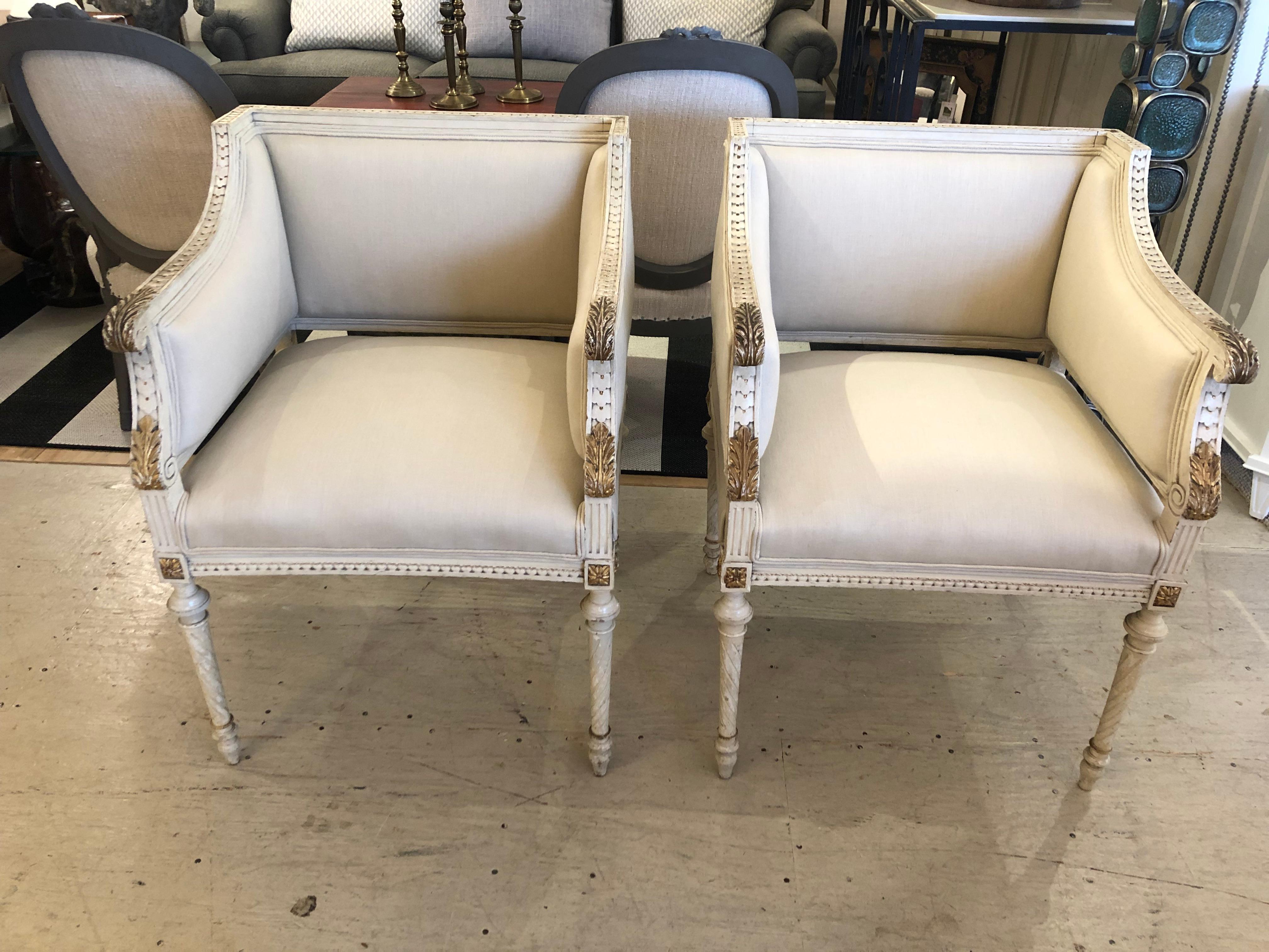 Superb elegant pair of comfortable Paris club chairs having a rare square shape, beautiful carved wood frames with original early paint and gilded details. Newly upholstered in off white linen. Incredible from every angle.
arm height 28