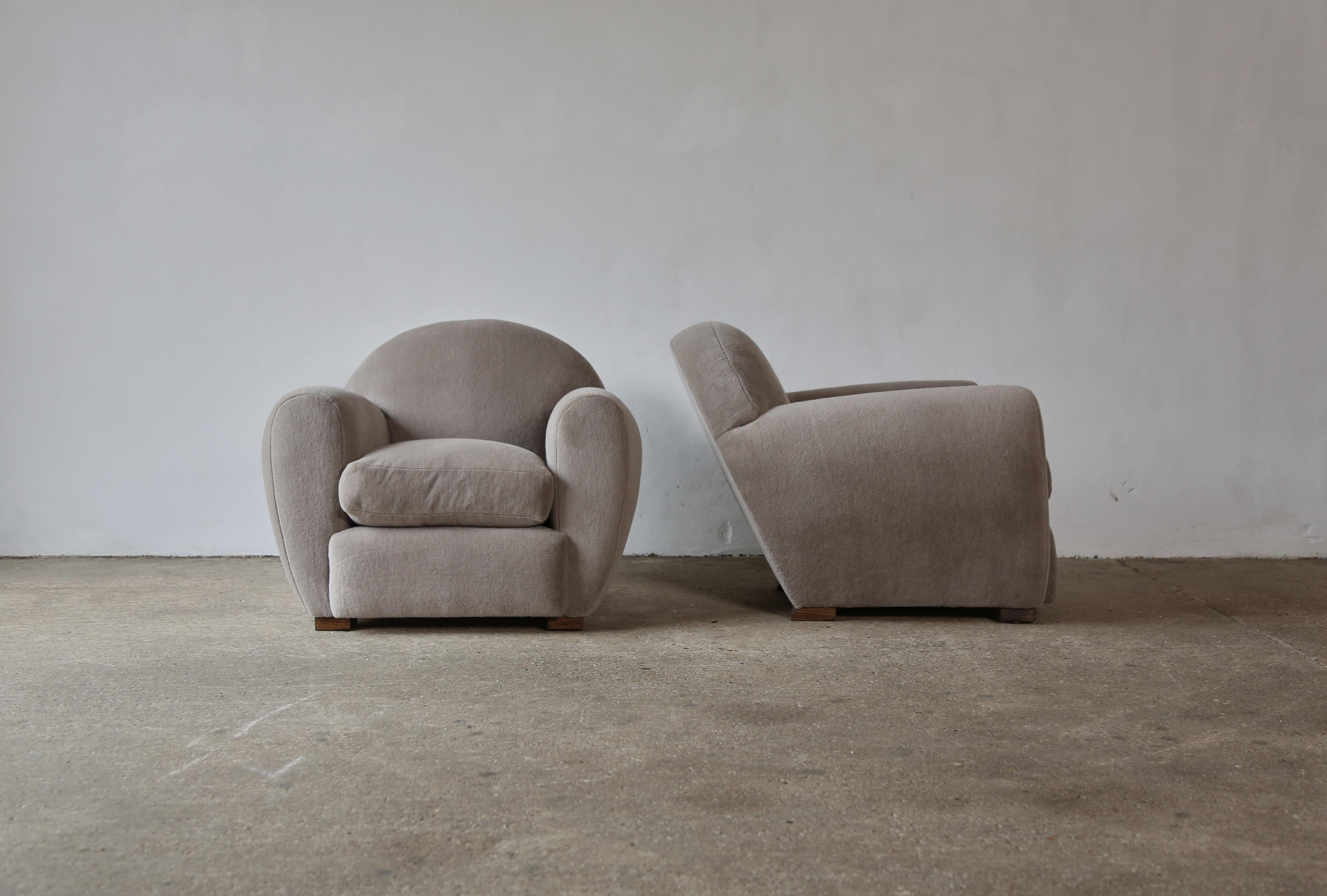 Superb pair of round, leaning modern club chairs, upholstered in pure Alpaca. High quality handmade beech frames and newly upholstered in a soft, grey (with a hint of brown) premium 100% alpaca wool fabric. 