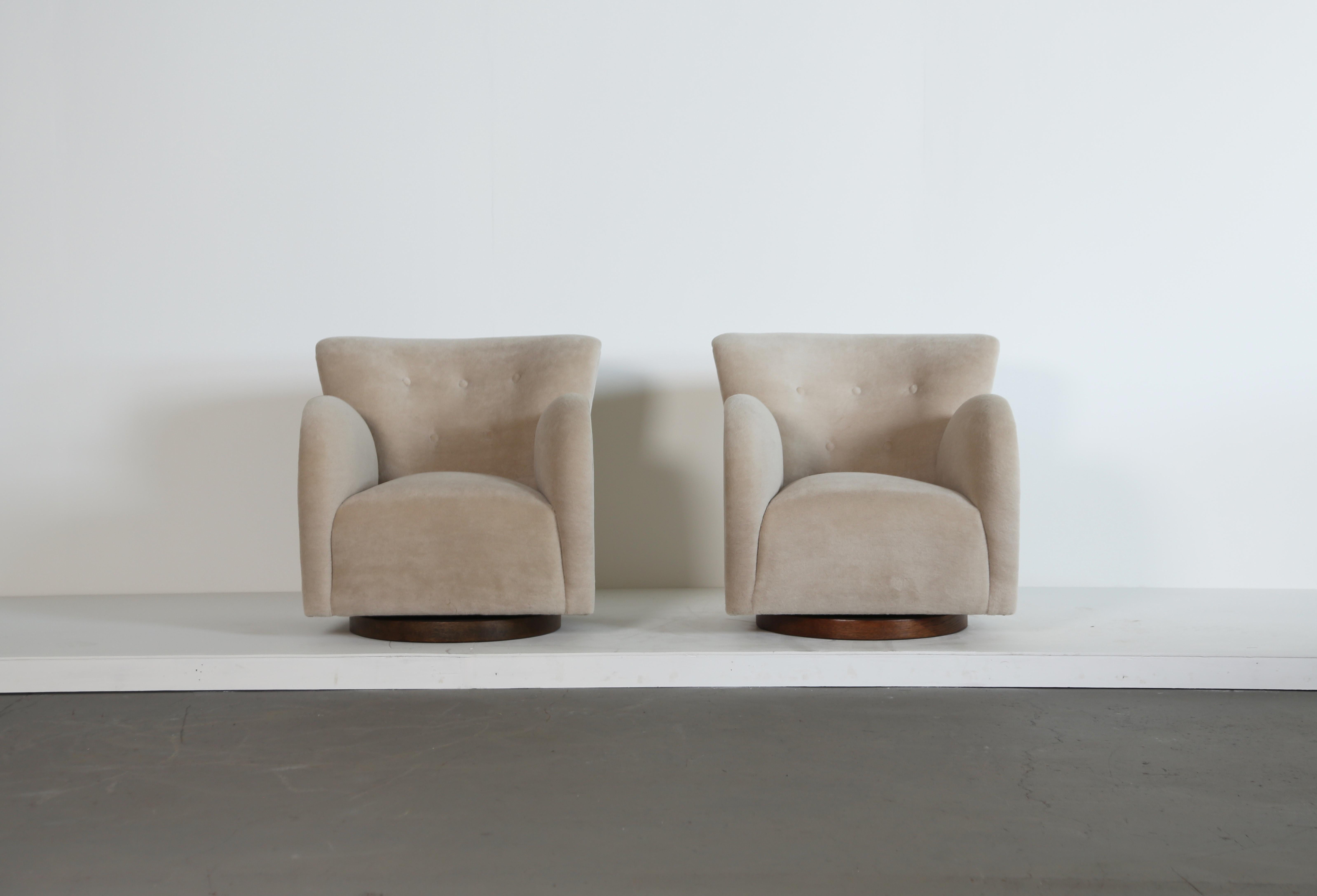 A superb pair of modern round arm swivel armchairs. Beech frames, sprung seat and to be upholstered in customer supplied fabric, on a wooden base.   Swivels 90 degrees in each direction with return mechanism.   Handmade in England.   Fast shipping
