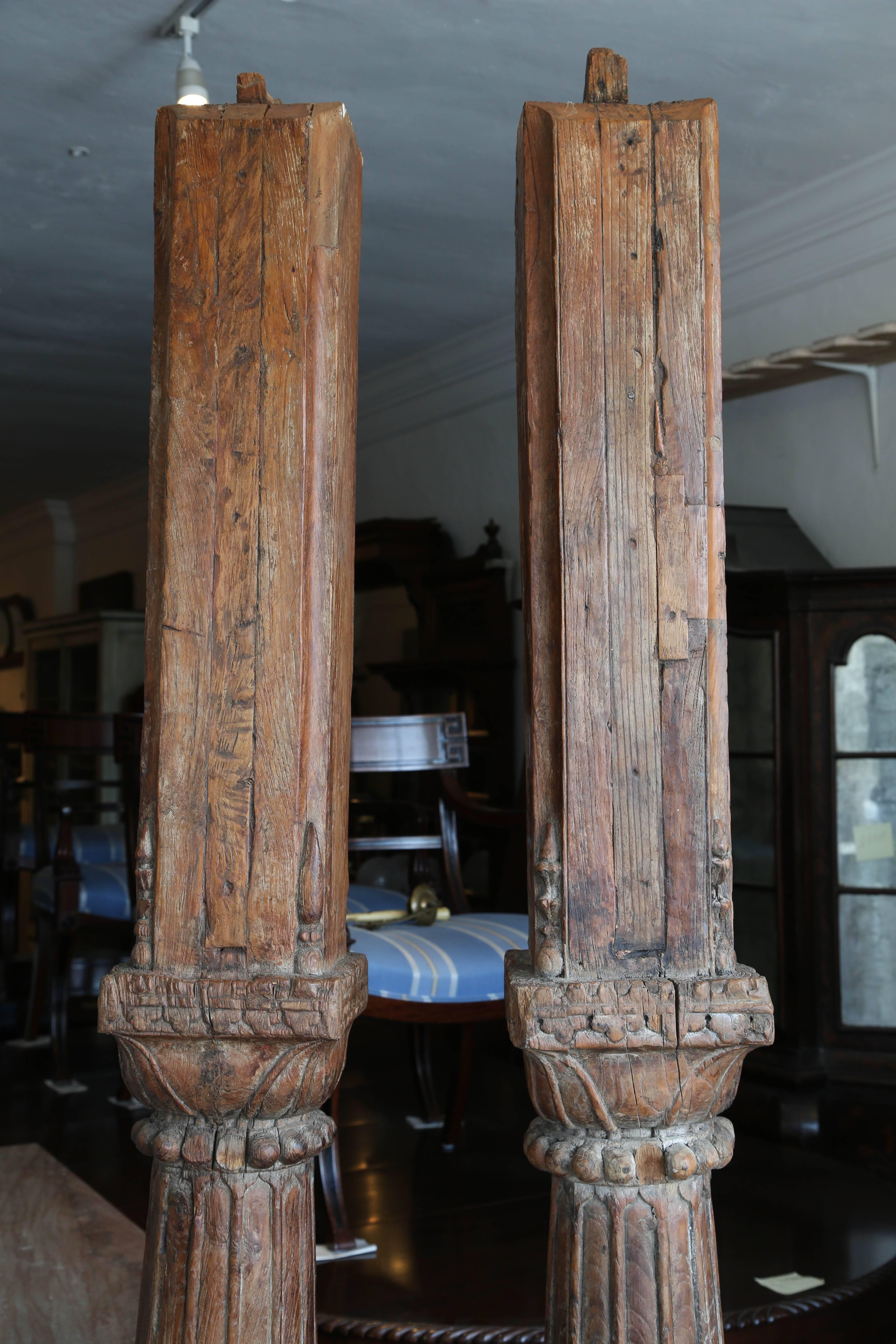 These are very nice pair of antique Wood with stone base pillars or columns.

It looks like they are solid oak with some fine carvings.
There is a cut out to one side with a lip to the top, which makes me believe it could have been an entrance at