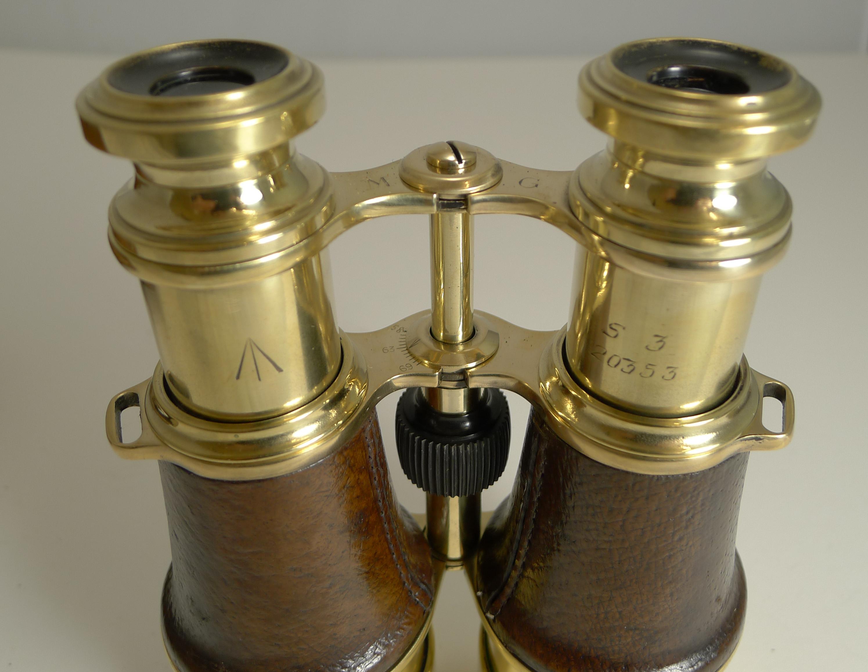 A fabulous pair of World War I British Officers Military binoculars with both the brass on the binoculars and the leather case with the British military crows foot mark. The case is also stamped with the London retailer 