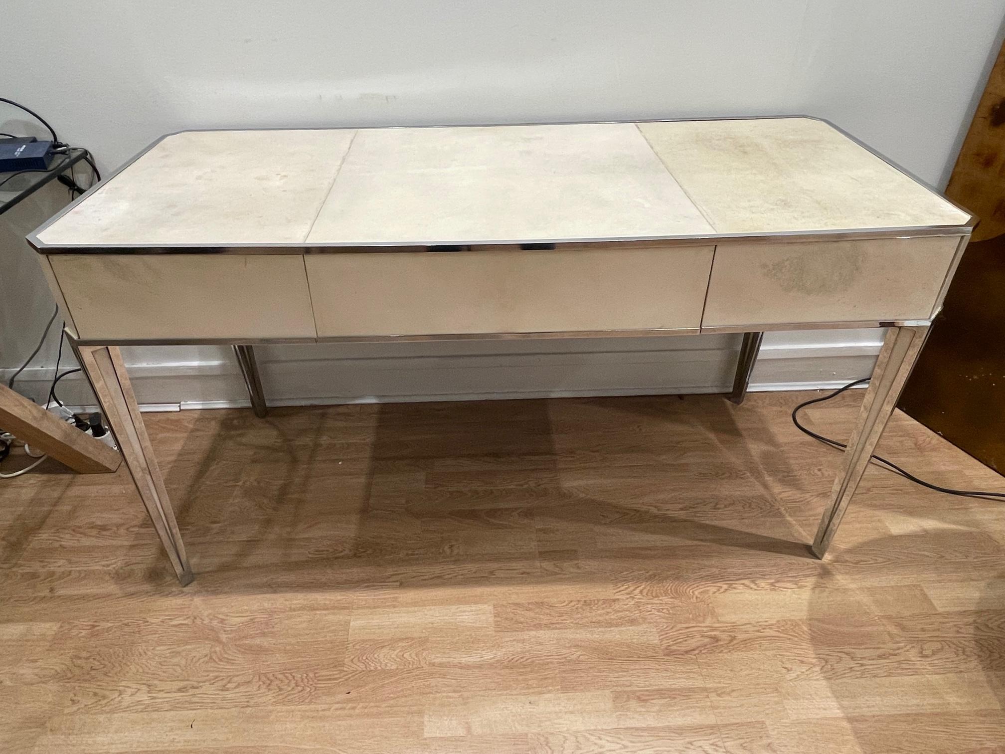 Superb Art Deco desk/secretaire by Primavera. It is made of a beech wood structure, all faces entirely covered with leather (parchment). All angles are reinforced with chromed metal. 3 large drawers wich occupy the full length and depth of the desk,
