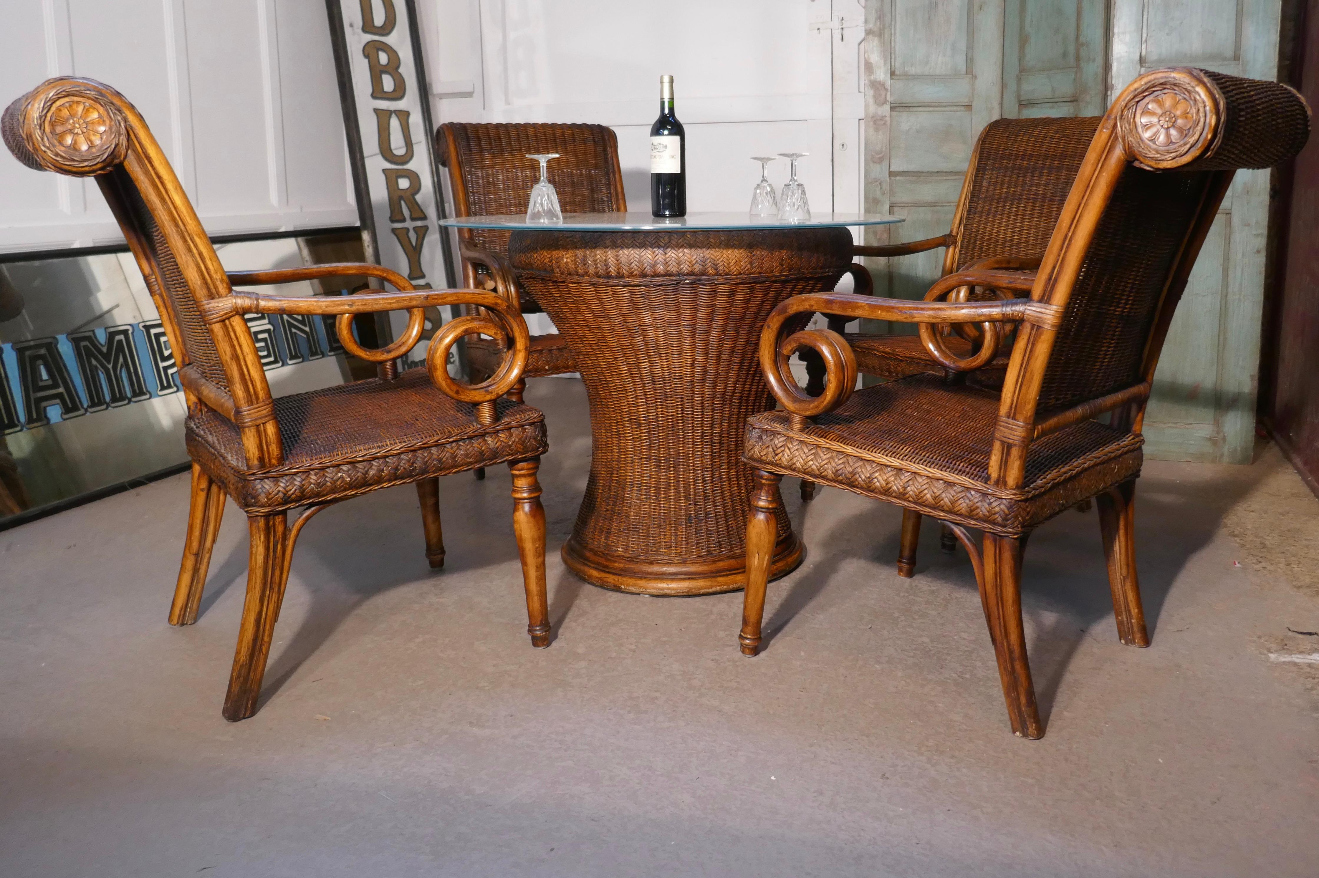 Superb plantation or bistro set of 4 cane and bentwood armchairs and table

The round table is very stylish and the heavy bentwood chairs have scroll arms and roll top backs
A wonderful set dating from the 20th century, this is a heavy quality