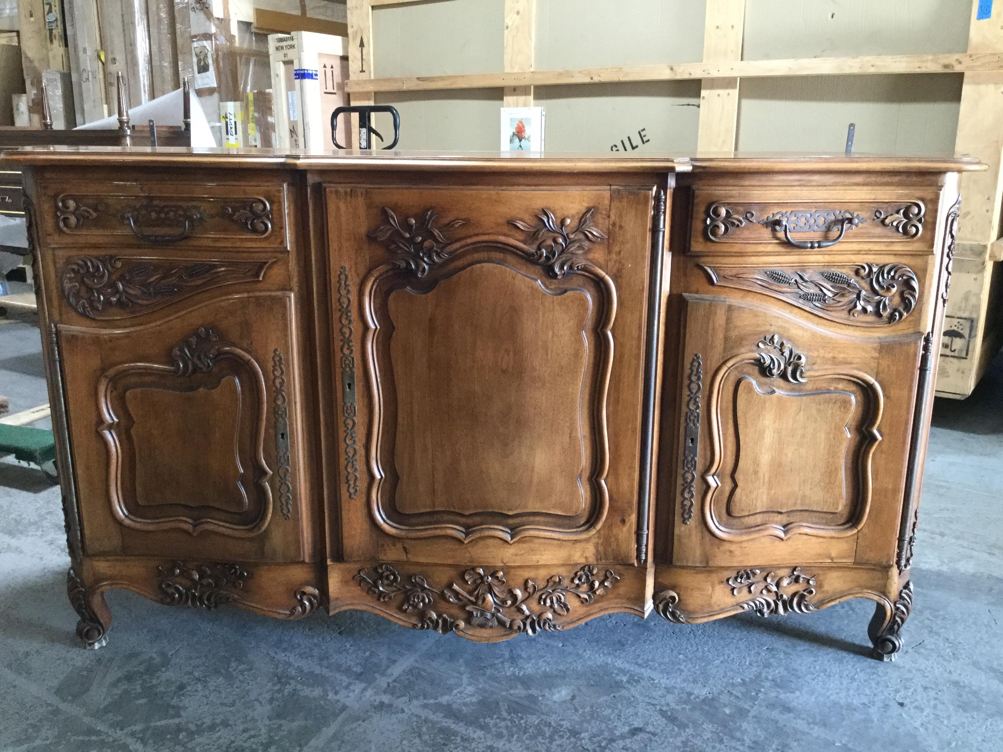 Provencal classic hand rubbed walnut buffet sideboard, having gorgeous carvings which represent typical themes from the Provence region such as olive branche, leaves, wheat bundles, and floral motifs. Beautifully carved with rounded sides and plenty
