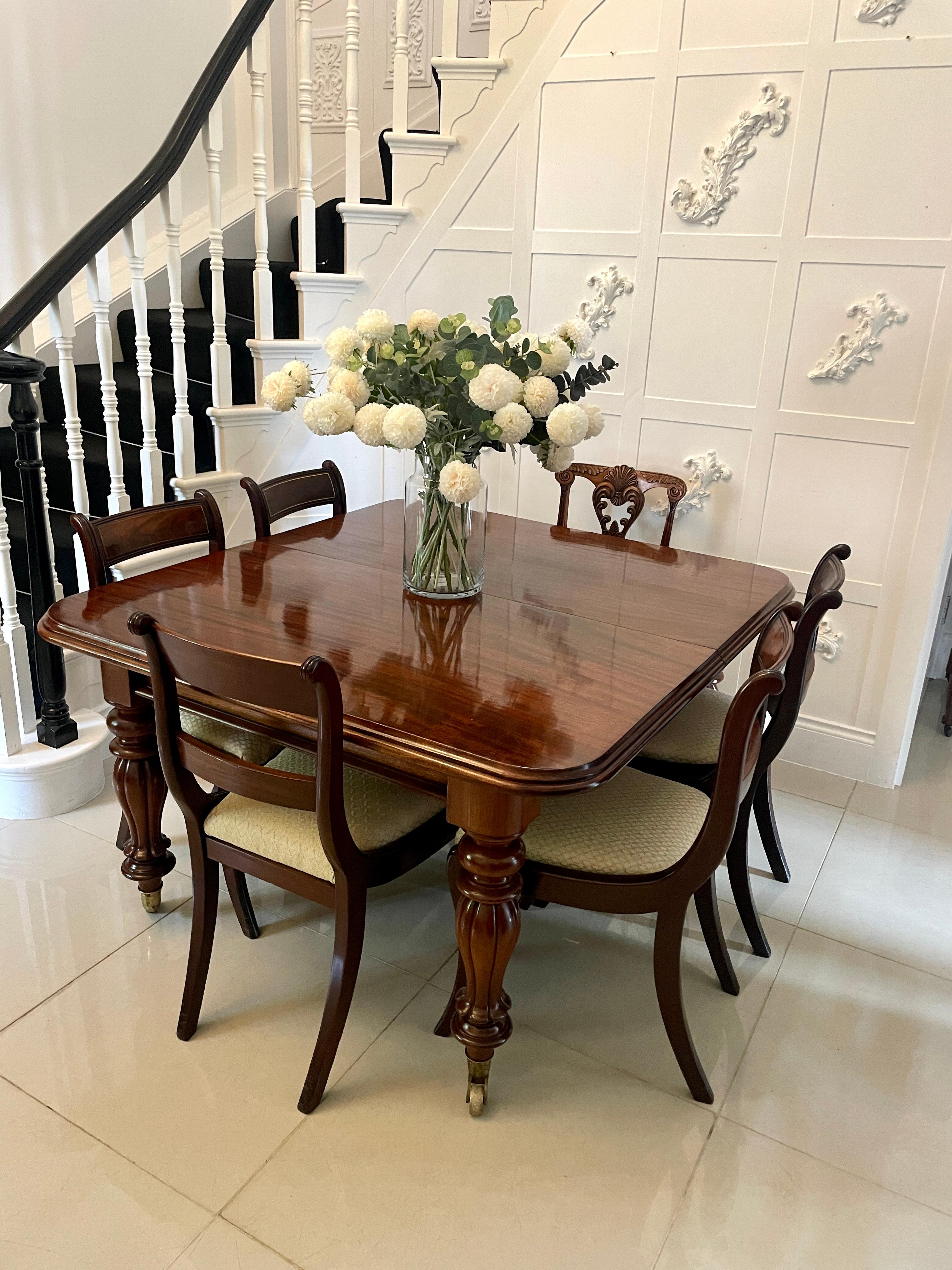 Superb quality antique Victorian figured mahogany extending dining table having a superb quality figured mahogany extending top with a double moulded edge, two large original figured mahogany extra leaves, pull out extending action, mahogany frieze