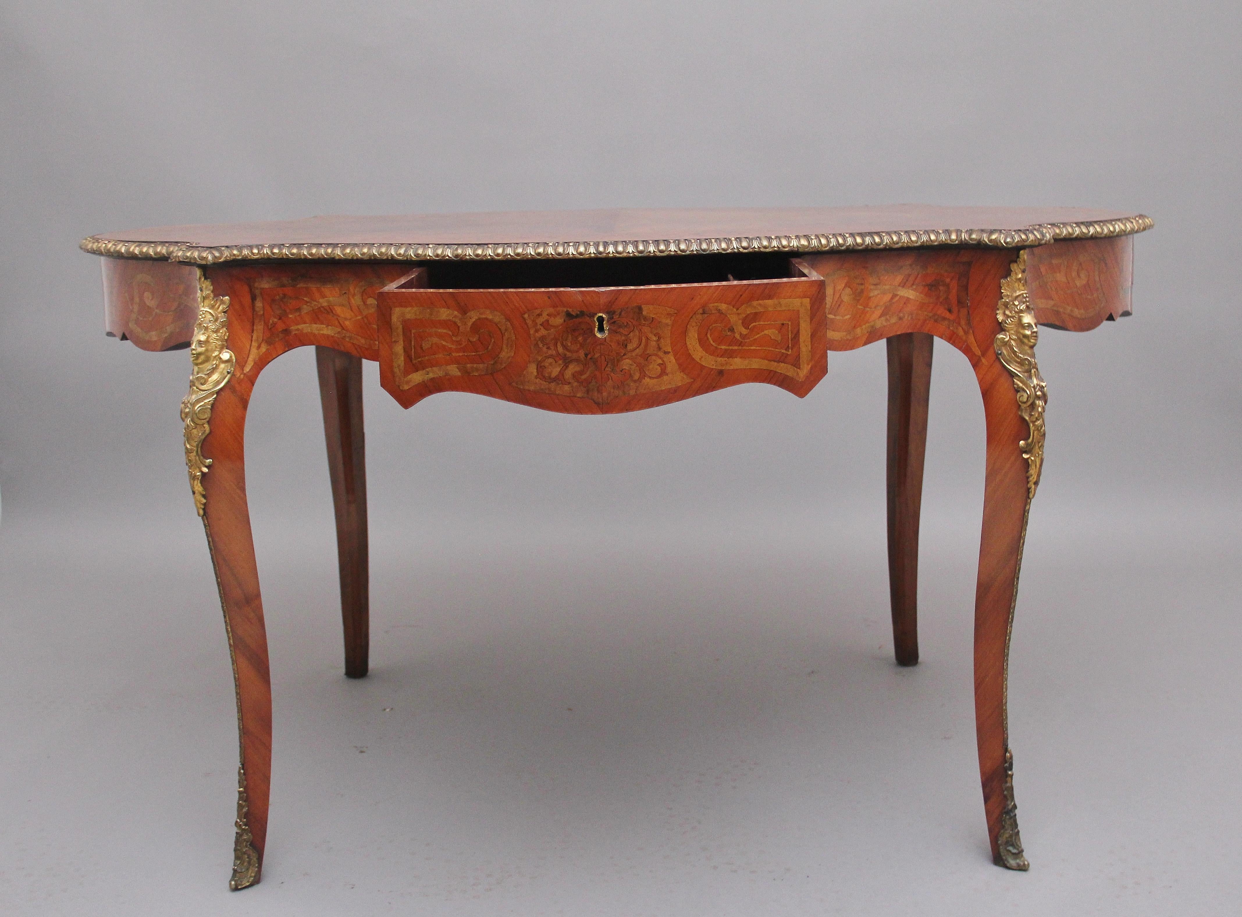 A superb quality 19th Century walnut and inlaid centre table, the shaped top profusely inlaid with various decorative patterns, having an oval panel at the centre with a lovely figured quarter veneered top, finely carved ormolu moulded edge running