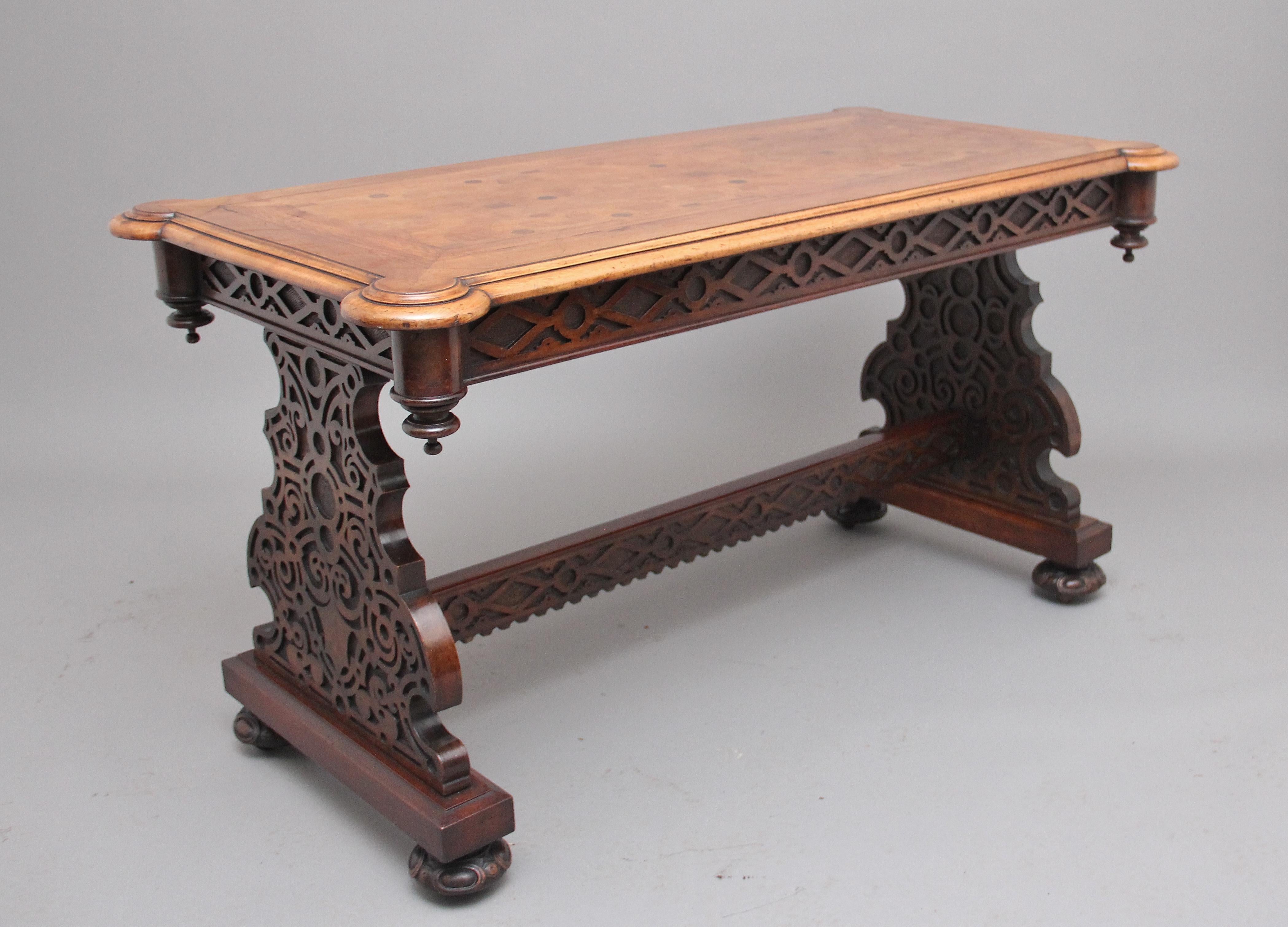 A superb quality 19th century walnut and oak inlaid library / centre table, having a moulded edge top with rounded corners, highly decorative inlaid top with oak inlay, pierced and carved frieze below with circular columns in each corner decorated