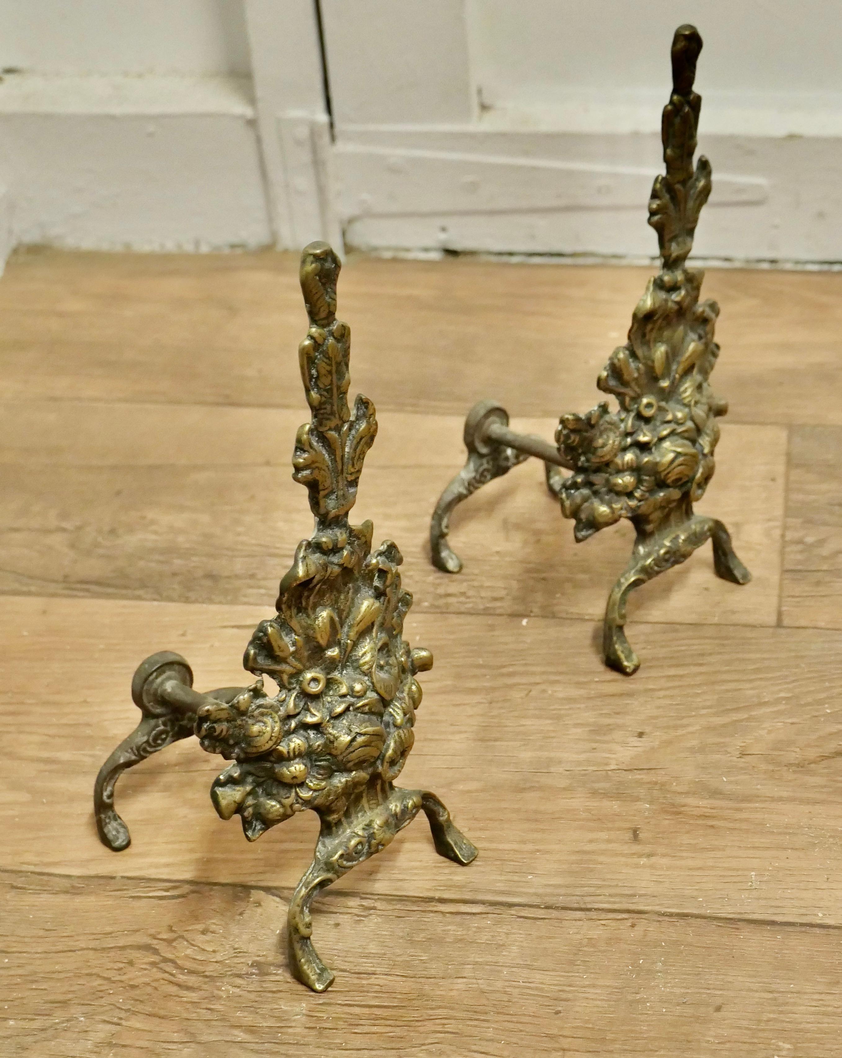 Superb Quality and Design 19th Century Brass Andirons

This is a superb quality pair they are decorated with garlands of leafy swags and floral decoration  
 
The andirons are in good condition they are 12” high, 5” wide and 6” deep
TSC69