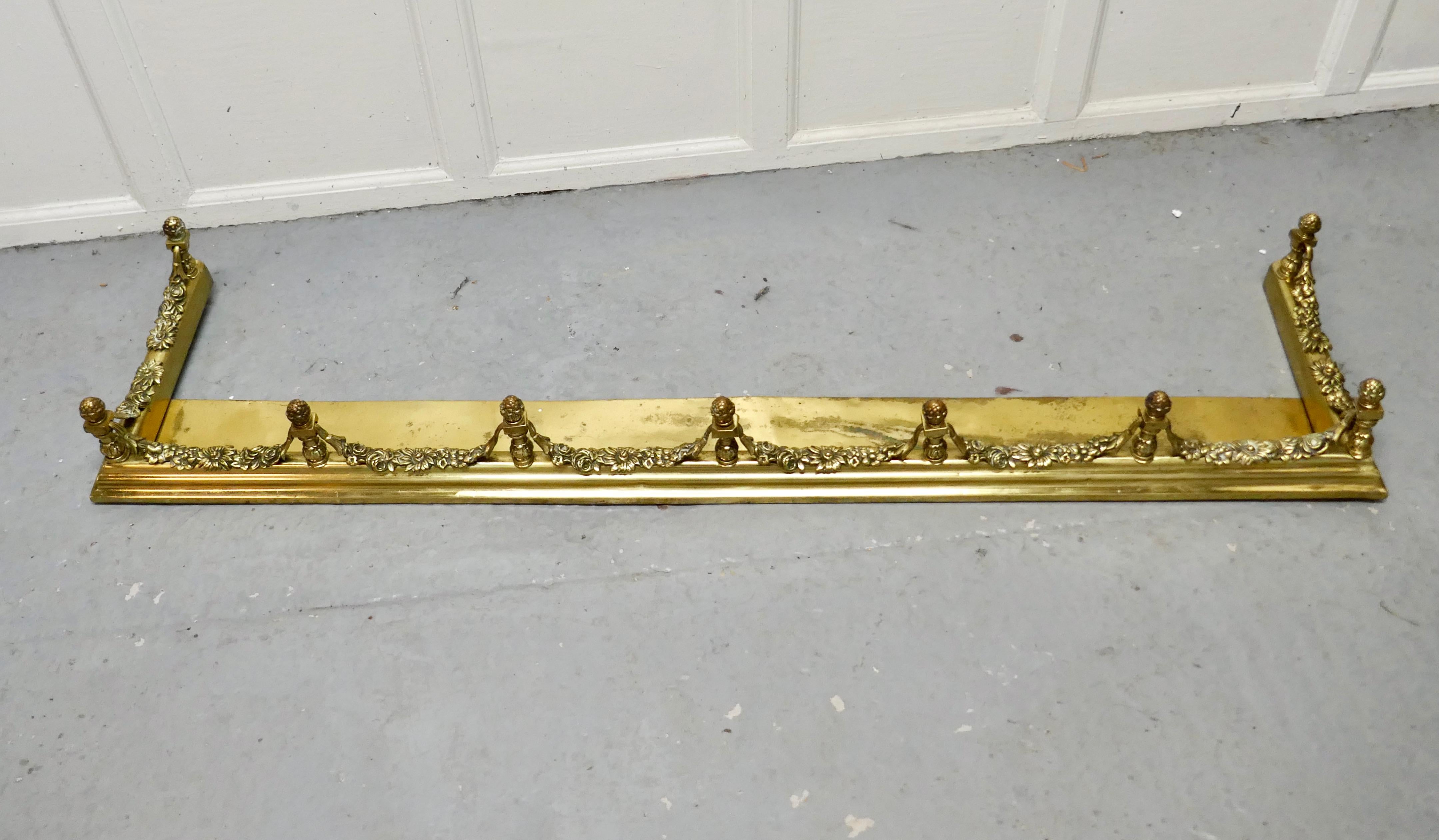 Superb quality and design 19th century heavy brass fender

This is a superb quality brass fender it has a broad base and elaborate spindles, with garlands of leafy swags this is one of the heaviest and finest quality fenders 
The fender has