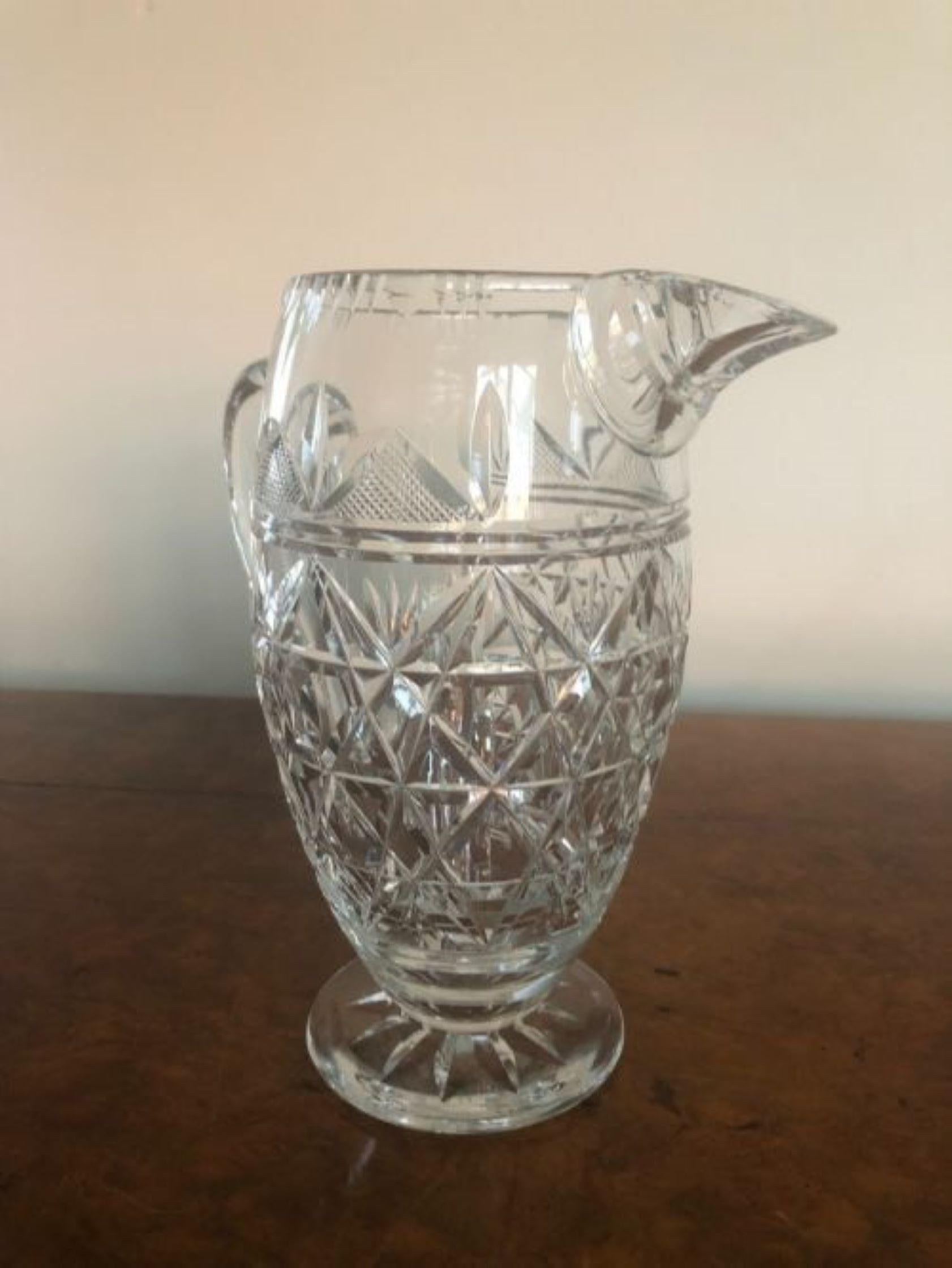 Superb quality antique cut glass water jug. Superb quality cut glass water jug with a shaped handle, raised on a round cut glass base