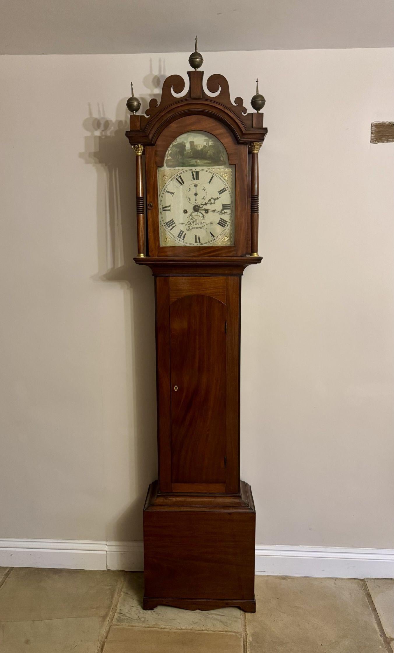 Superb quality antique George III mahogany arch dial longcase clock, having a quality antique George III mahogany longcase clock with a mahogany hood finished with three brass finals above turned columns with gilt metal Corinthian capital mounts