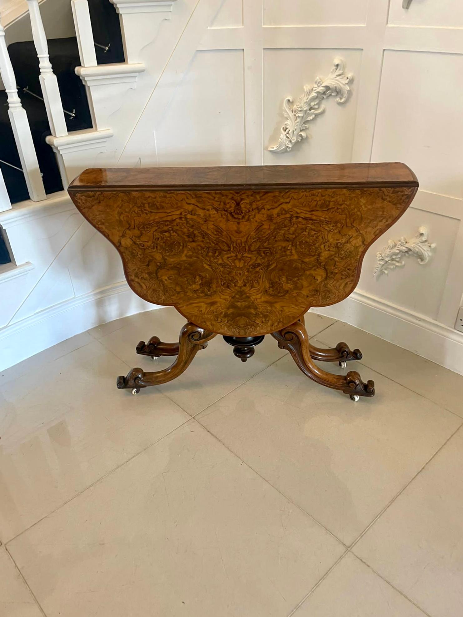 Superb quality antique Victorian burr walnut Sutherland table having a magnificent quality serpentine shaped burr walnut top with two drop leaves and a moulded edge standing on swing out shaped carved solid walnut cabriole legs with scroll feet on