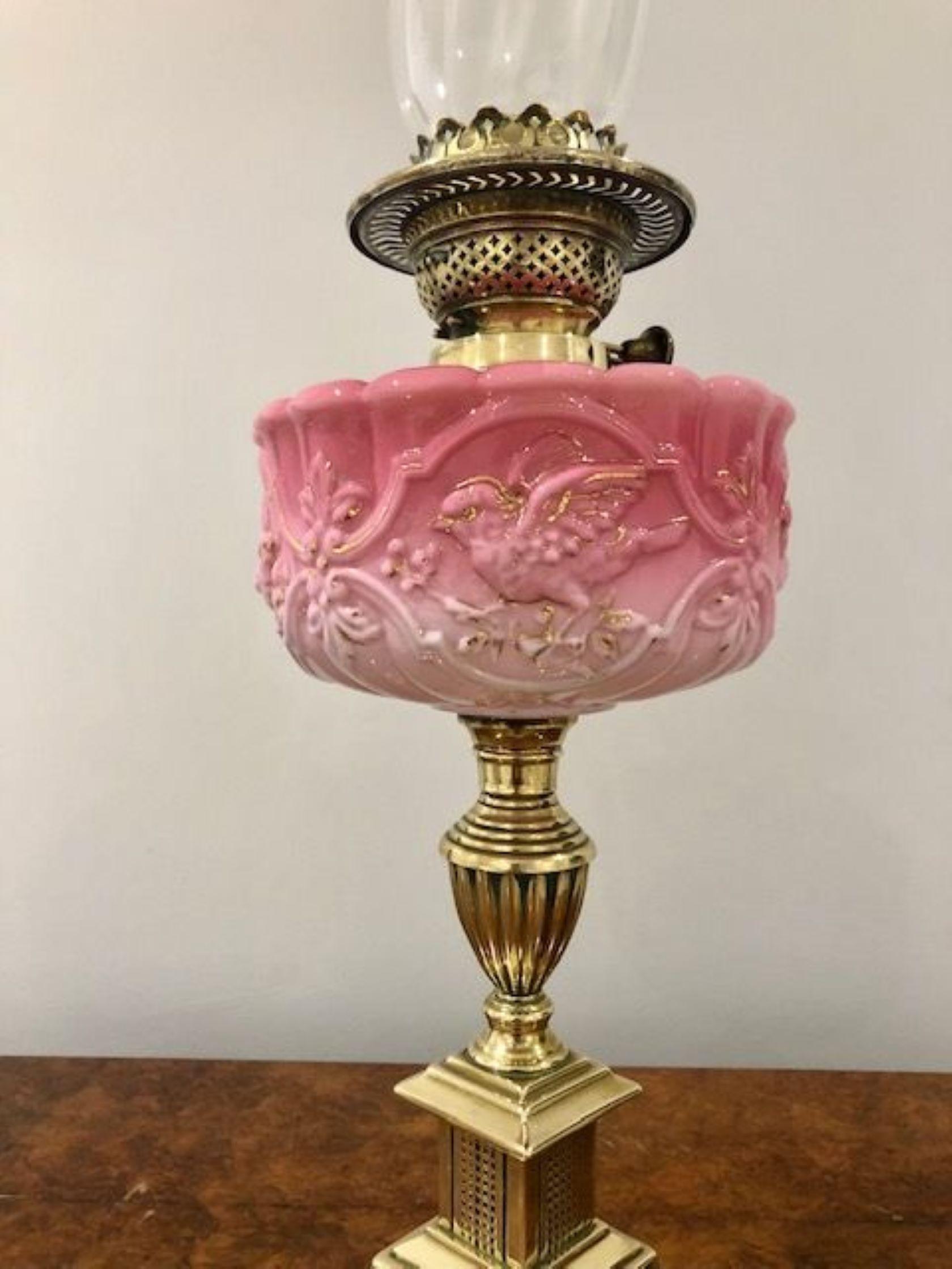 Superb quality antique Victorian oil lamp having a quality decorated glass shade and glass chimney with a double brass burner, lovely ornate pink glass reservoir supported by a brass turned column standing on a square stepped base 