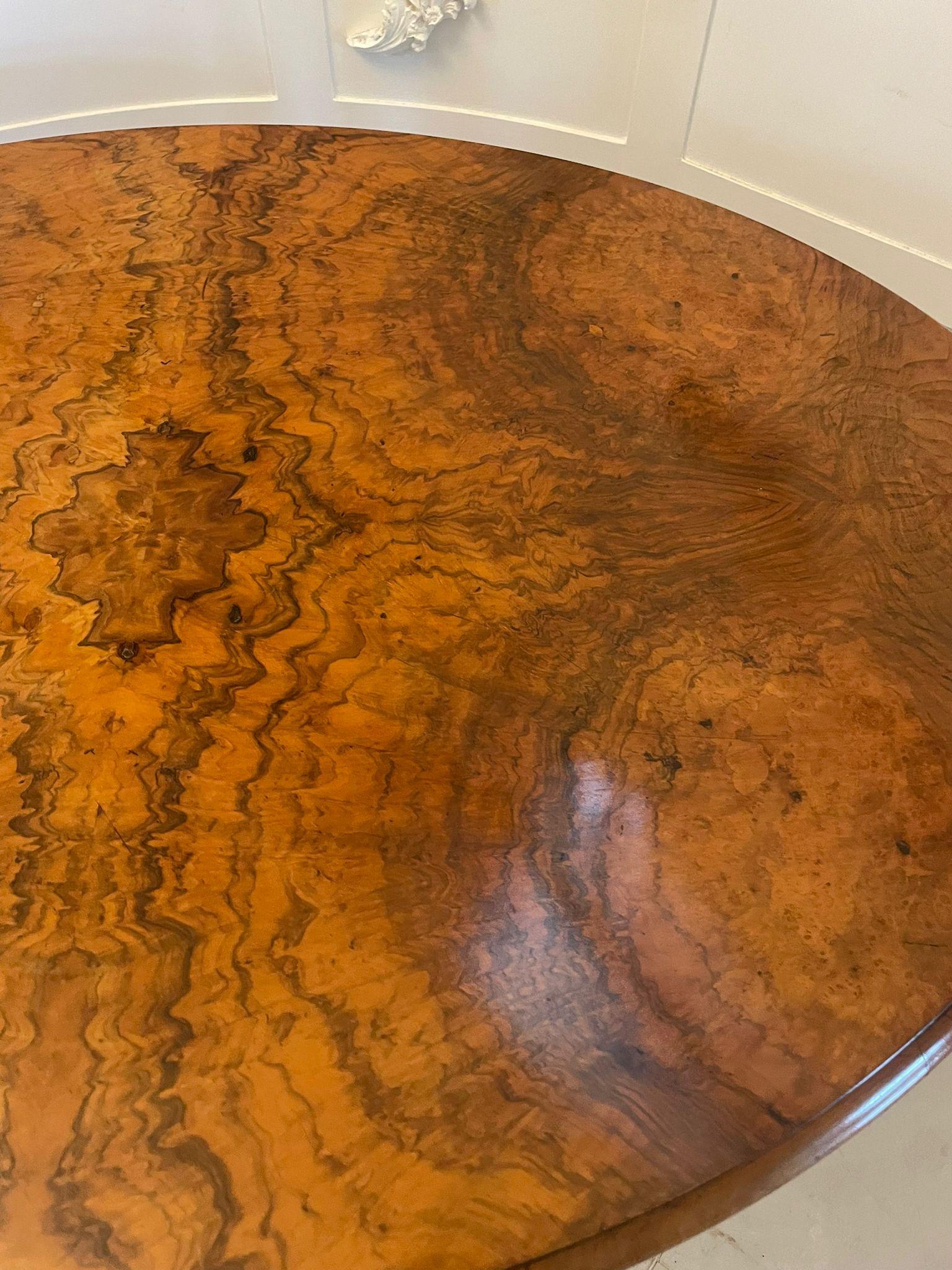 Superb quality antique Victorian oval burr walnut dining table having a superb quality burr walnut oval top with a thumb moulded edge supported by a carved solid walnut pedestal column standing on four shaped carved cabriole legs with scroll feet
