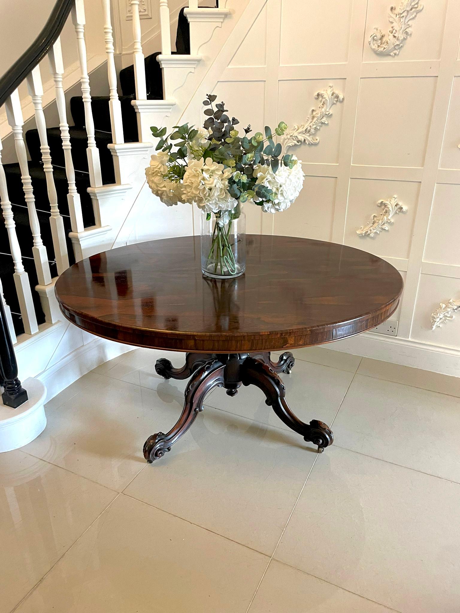 Superb quality antique Victorian oval rosewood centre/dining table having a superb quality oval figured rosewood tilt top with a rosewood frieze supported by a shaped turned solid carved rosewood pedestal column standing on shaped carved cabriole