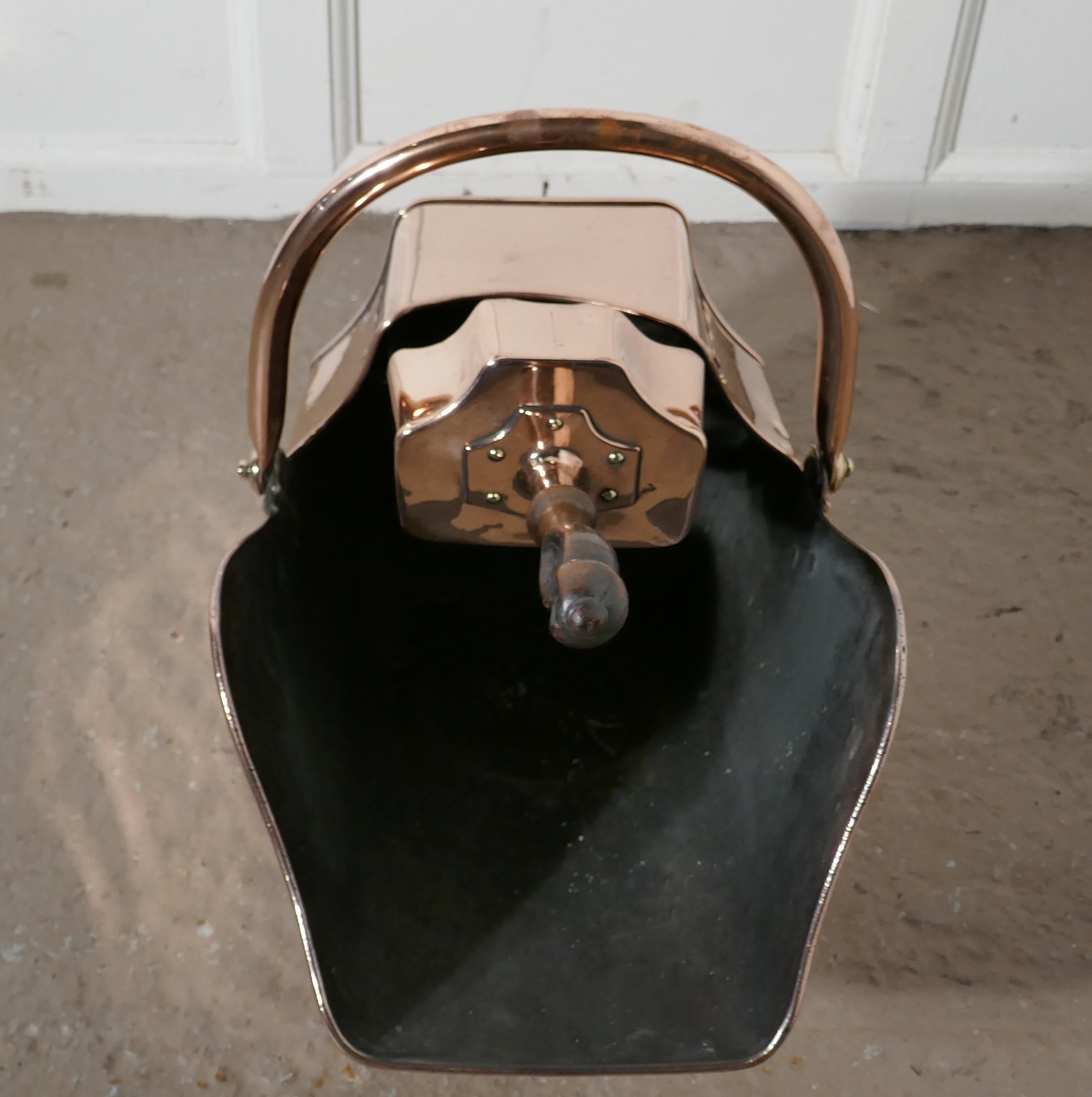 Superb quality Arts & Crafts copper helmet coal scuttle.

This very top quality piece is a very unusual shape, it is in style the same as most enclosed coal scuttles and has the added advantage of retaining it original shovel which fits neatly
