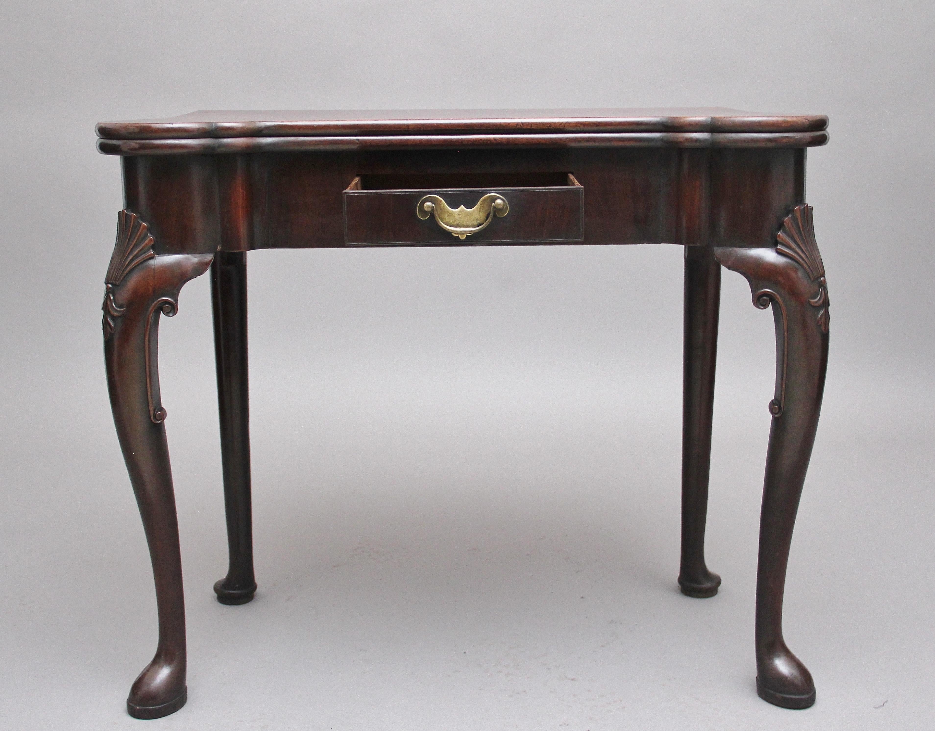 A superb quality early 18th century mahogany card table, possibly Irish, the shaped hinged fold over top having a lovely figuration, folding over to reveal green baize playing surface, candle stands and guinea wells, supported by a gate leg, having