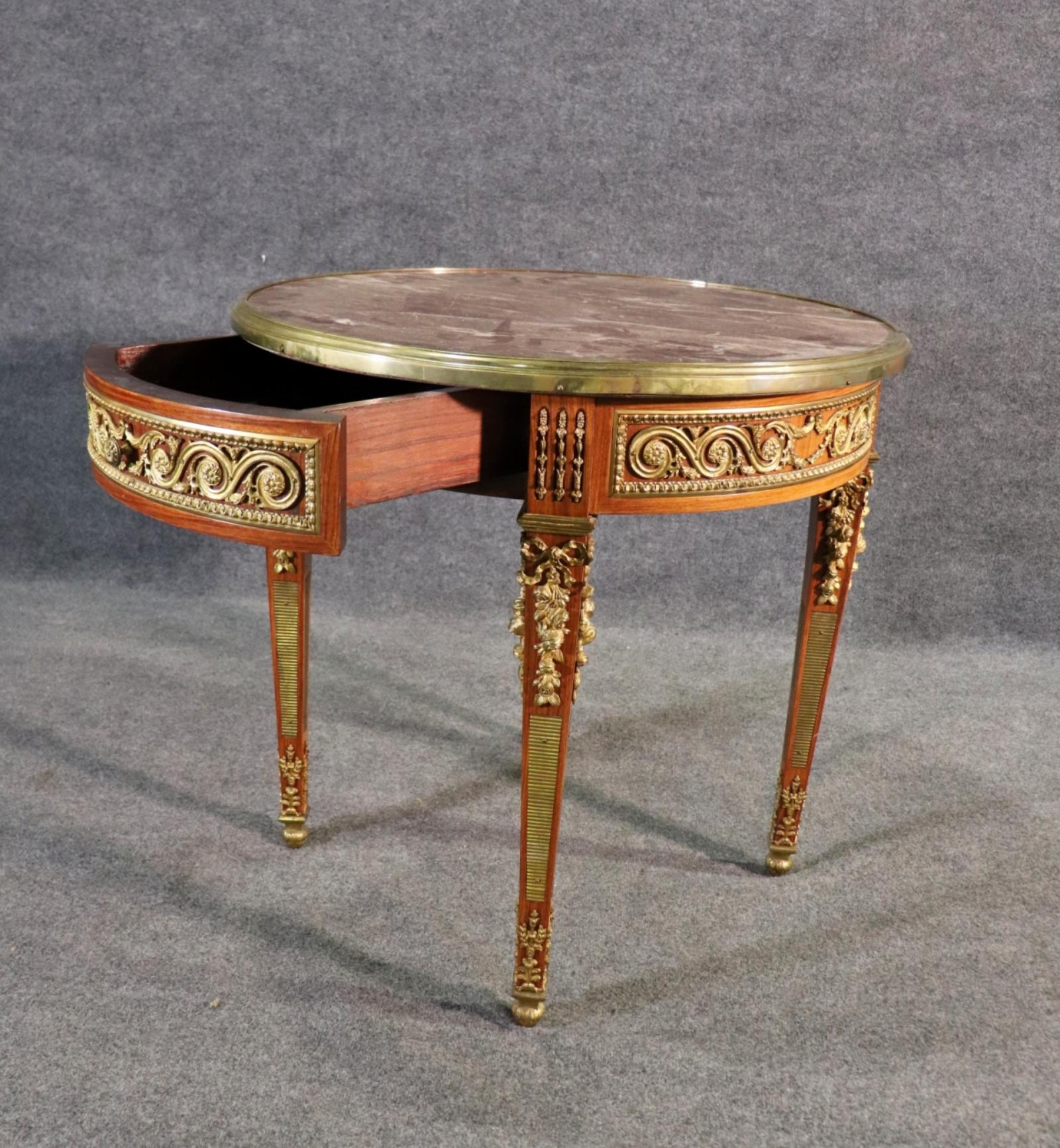 French Empire Marble Top Ormolu Center Table or accent table. Marble top with  Brass accent and hardware. Single pull-out drawer. 

Dimensions:  30 7/8