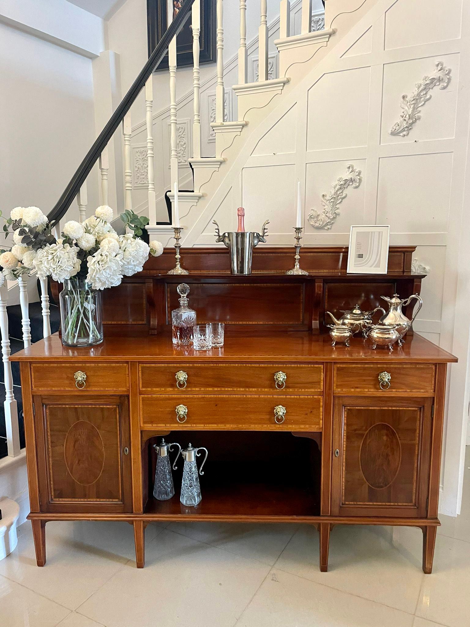 Superb quality large antique Edwardian mahogany inlaid sideboard having a mahogany and satinwood inlaid gallery back with a shelf, rectangular shape quality mahogany top crossbanded in satinwood above four drawers with original brass lions head