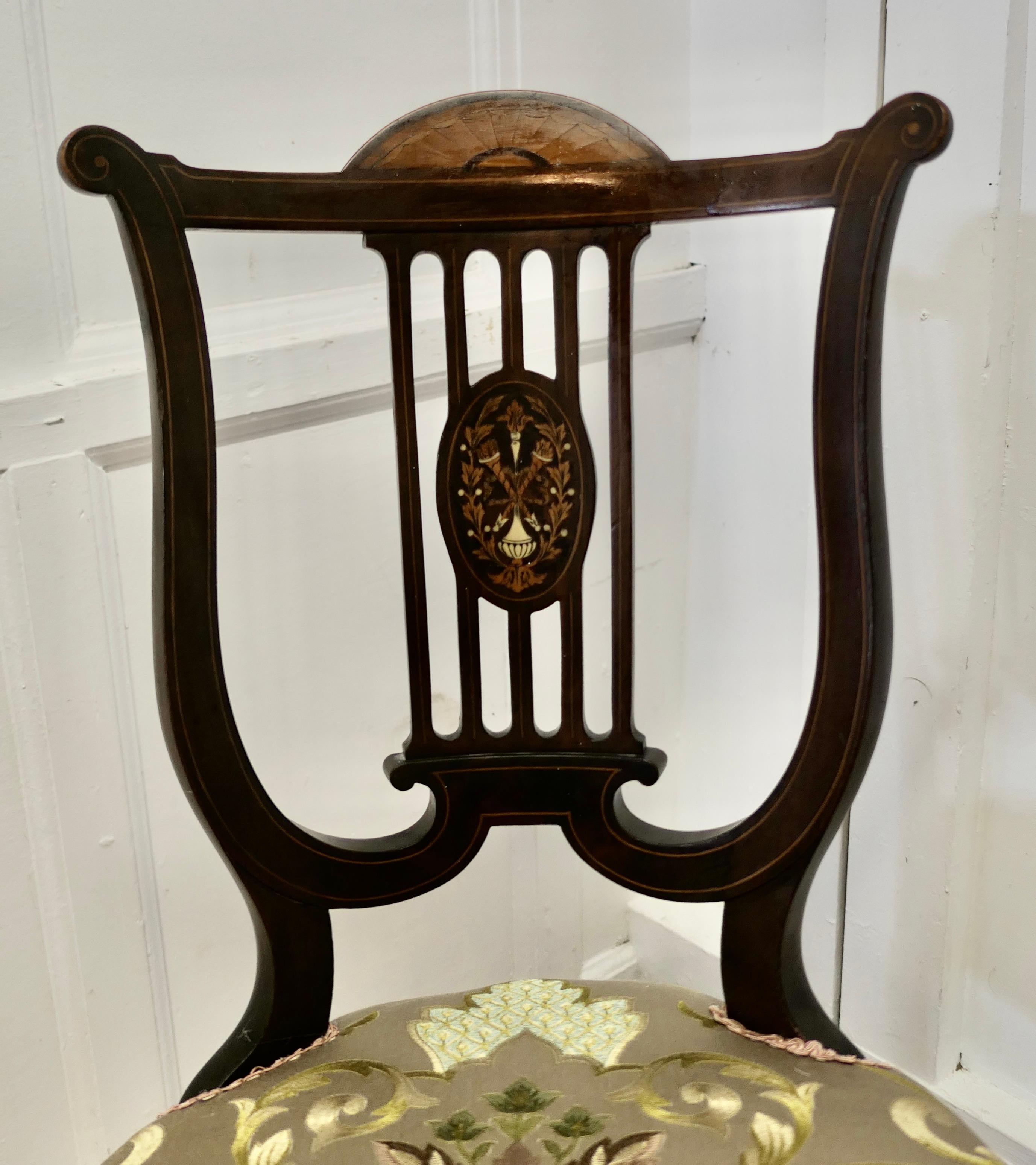 Superb Quality Lyre Back Revolving Harpist/Cello Music Chair

This is a really lovely fine quality Lyre back chair, the back has a very fine decorative cartouche and the seat has been upholstered with silk brocade 
The chair revolves, raising the