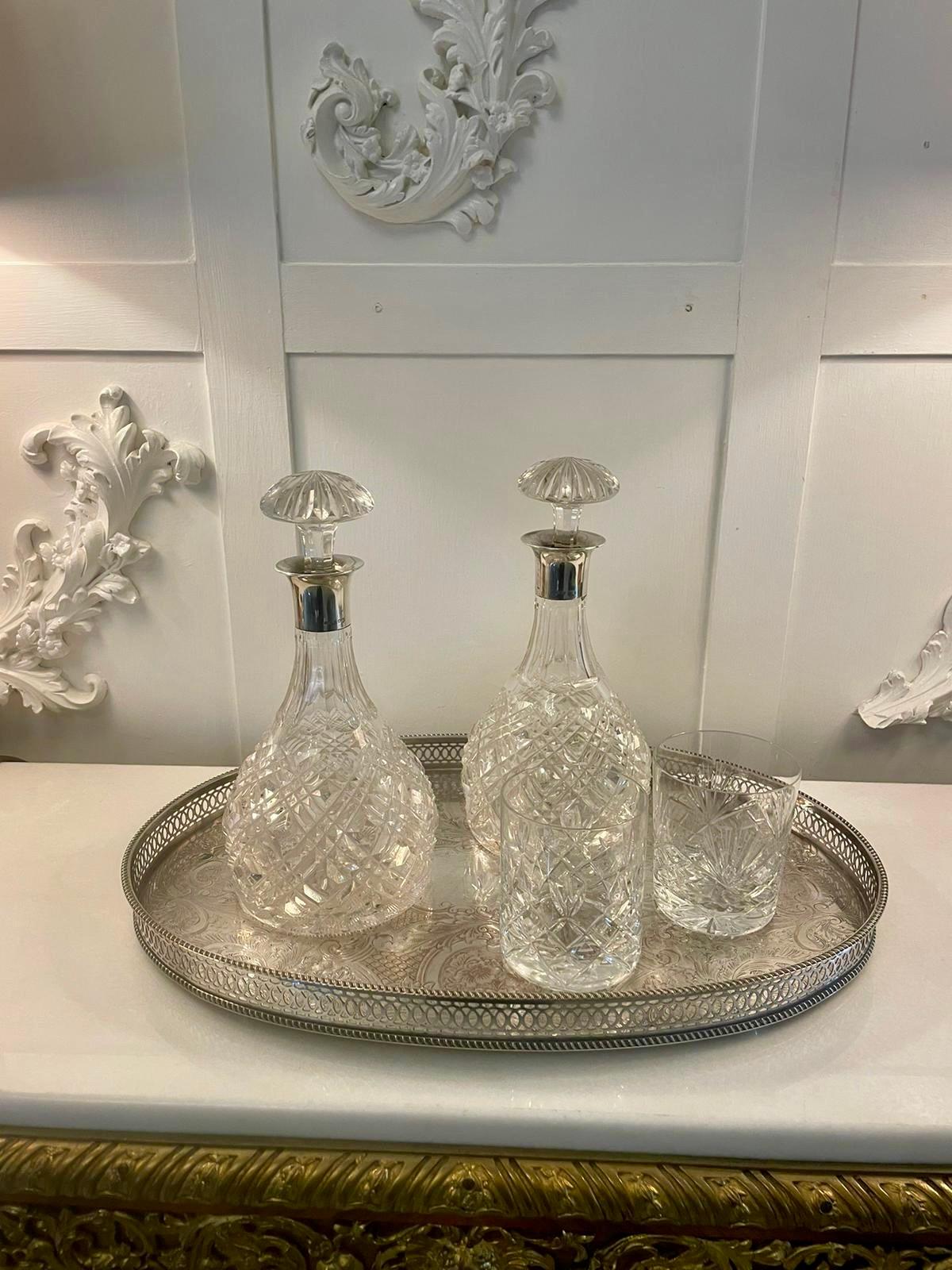 Superb quality pair of antique Edwardian cut glass decanters with silver mounts having the original cut glass stoppers, hallmarked solid silver mounts on a quality pair of shaped cut glass decanters


A charming decorative pair of first class