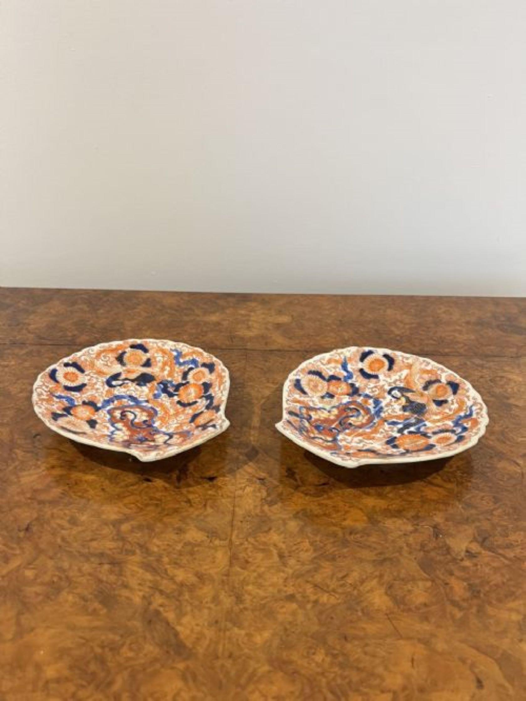 Superb quality pair of antique Japanese Imari shell shaped plates having a superb quality pair of antique Japanese Imari scalloped shell shaped plates with fantastic decoration with flowers, birds and scrolls hand painted in wonderful gold, red,