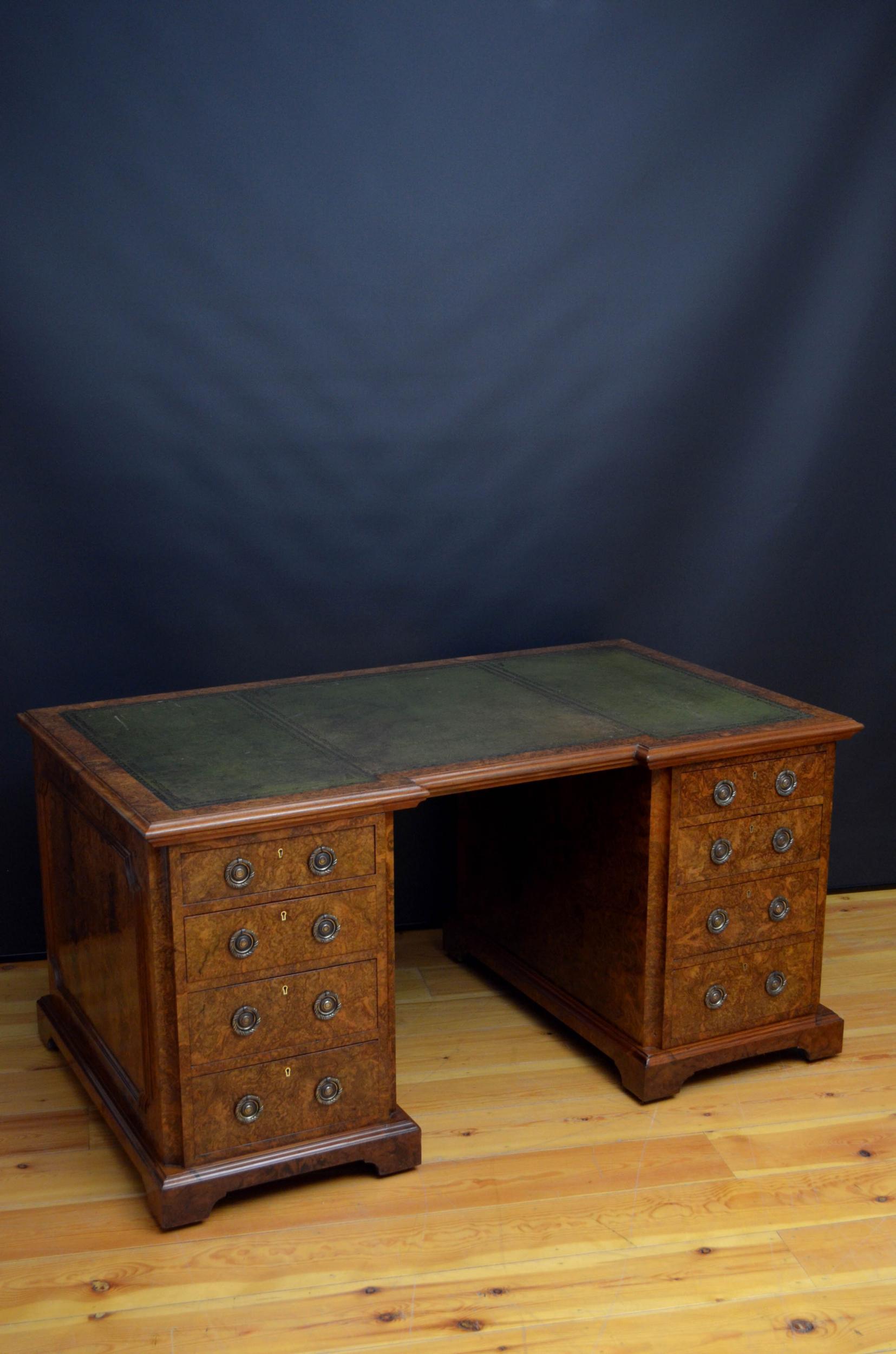 Exceptional quality Victorian pedestal desk in burr walnut, having original green tooled leather writing surface above 2 pedestals, each with 4 mahogany lined graduated drawers fitted with ring brass handles, standing on moulded plinth base, bracket