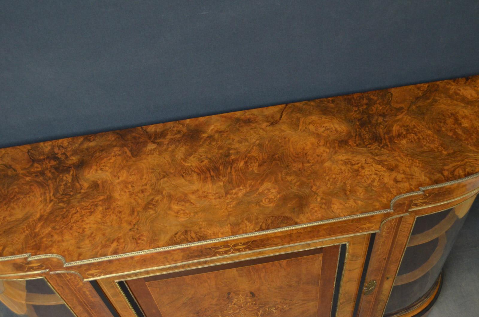 Sn4482, a superb quality and very impressive, Victorian burr and figured walnut credenza, having brass edge to top above finely inlaid frieze with gilt metal decoration, panelled cupboard door with marquetry inlay enclosing shelf, flanked by concave