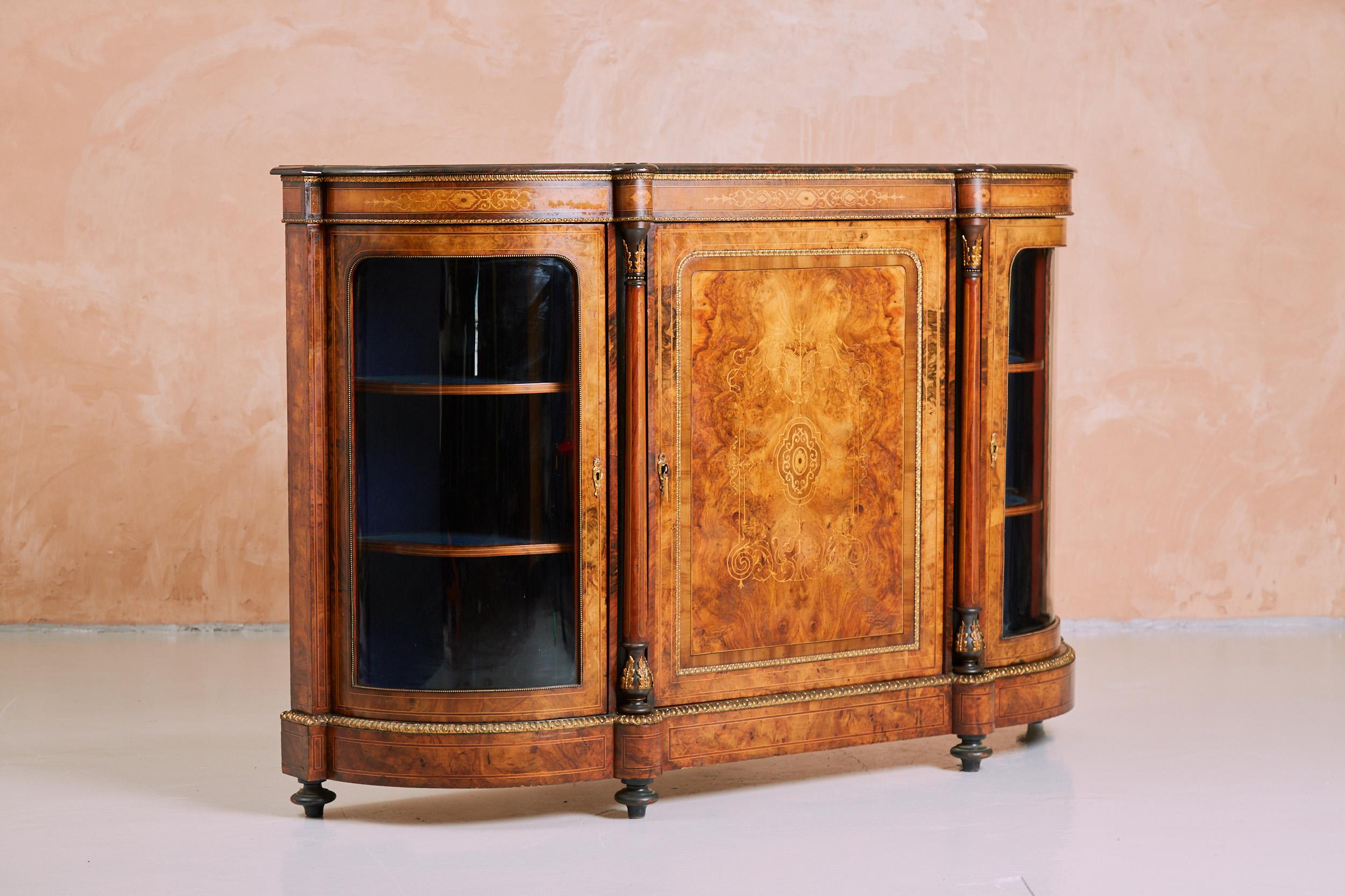 Circa 1860, superb quality large Victorian inlaid burr walnut credenza. 
The shaped top is in figured mirror-matched burr walnut with kingwood and boxwood inlay over an ormolu mounted frieze with inlaid boxwood plaques. 
There is a central door