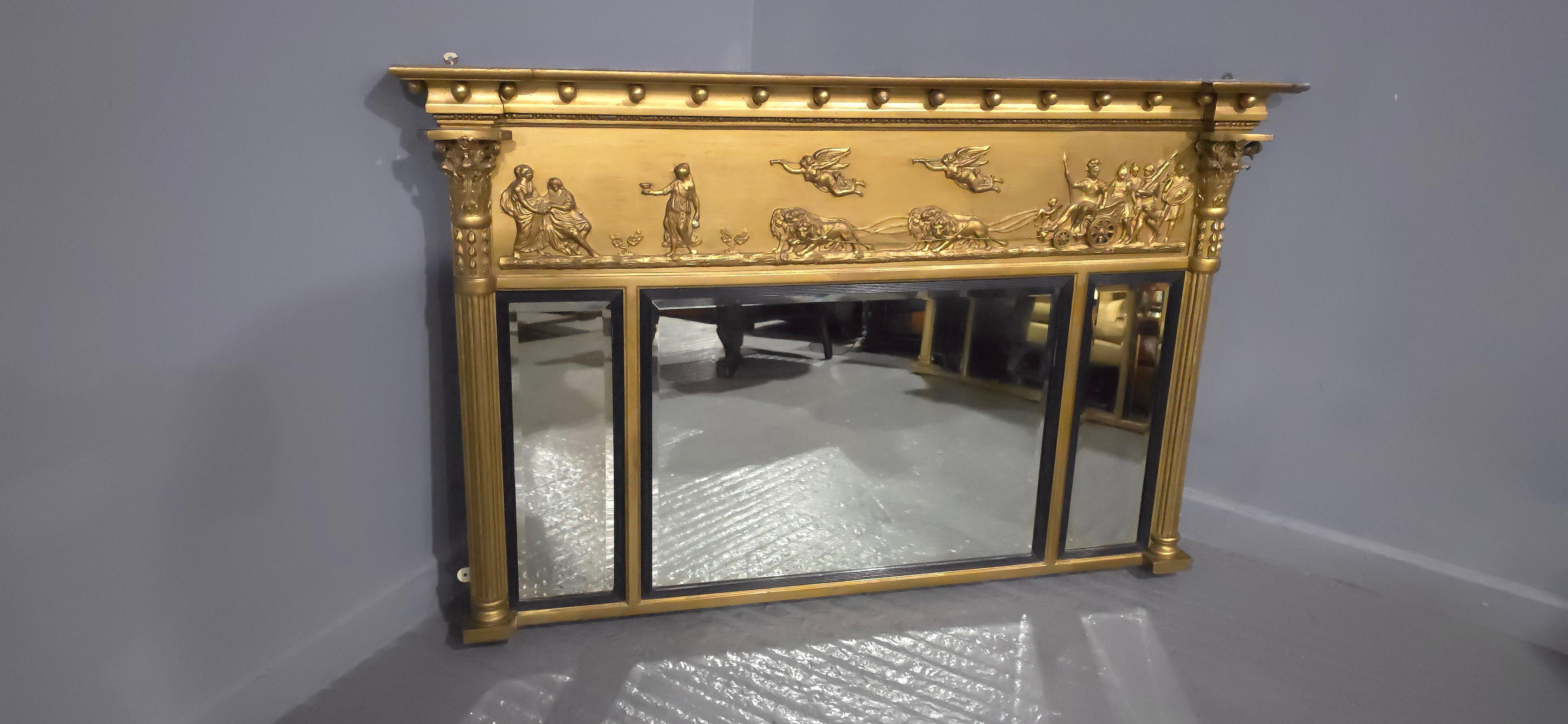 Fine quality Regency triptych gilt overmantle mirror, with charriot and angel decoration to the top black reeded mirror frames. original mirrors, in lovely condition.

35