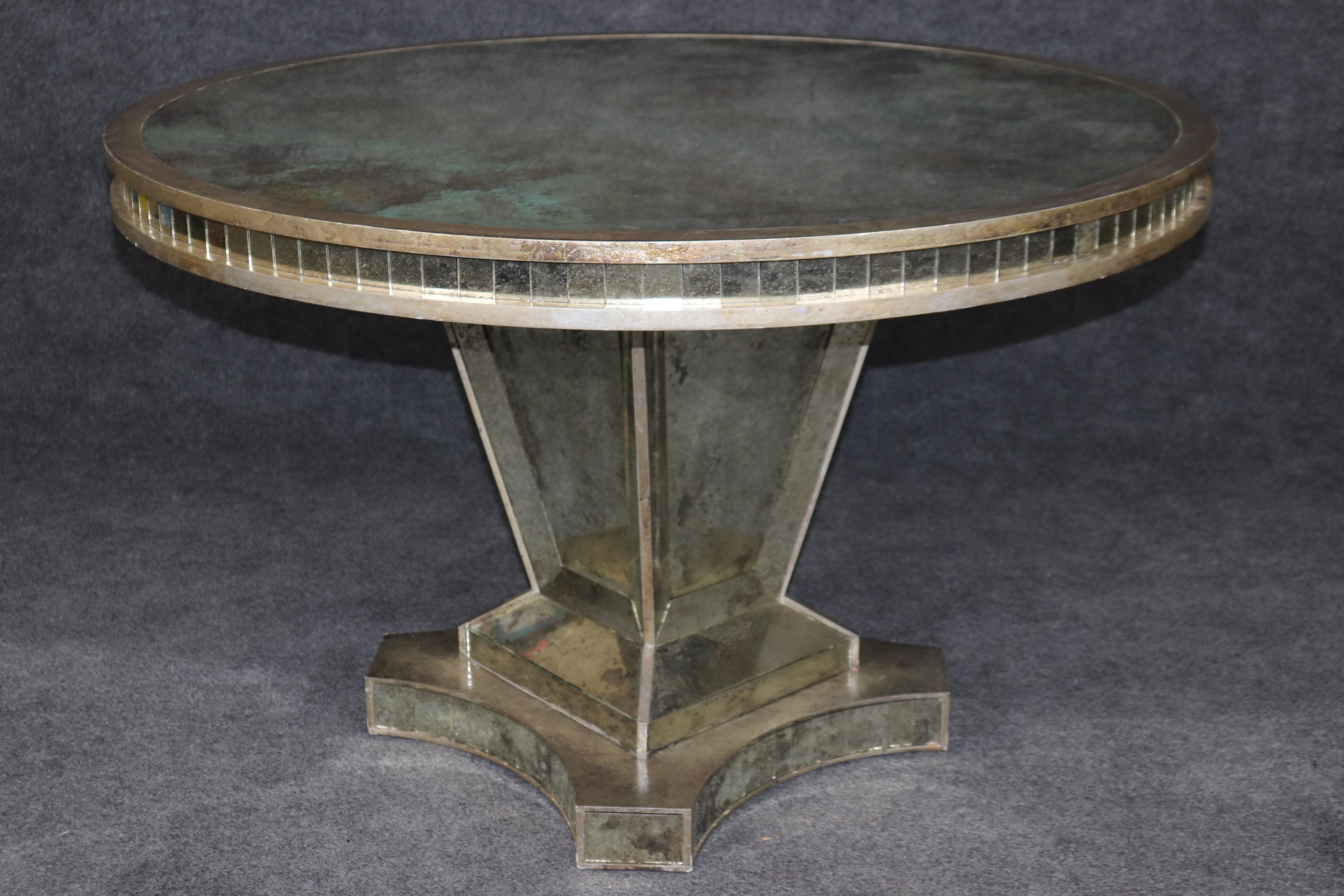 This is a stunning example of the finest the Italian deigns amd craftmanship. The table is designed with acid etched multi-colored silver-leafed eglomised mirror and every part of teh table is paneled in mirror. The table is in  very good condition