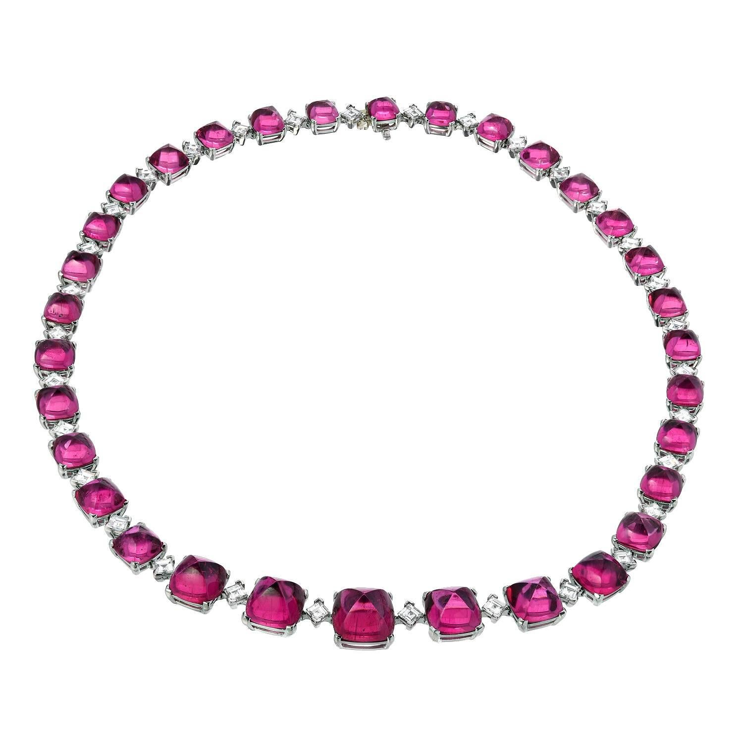 Superior 32 gradually custom-cut sugar loaf, cushion cut, cabochon Rubellite Tourmalines, weighing a total of 84.54 carats, are hand set in this one-of-a-kind 8.42 carat total diamond, platinum necklace.
Total length is 17 inches.
Returns are